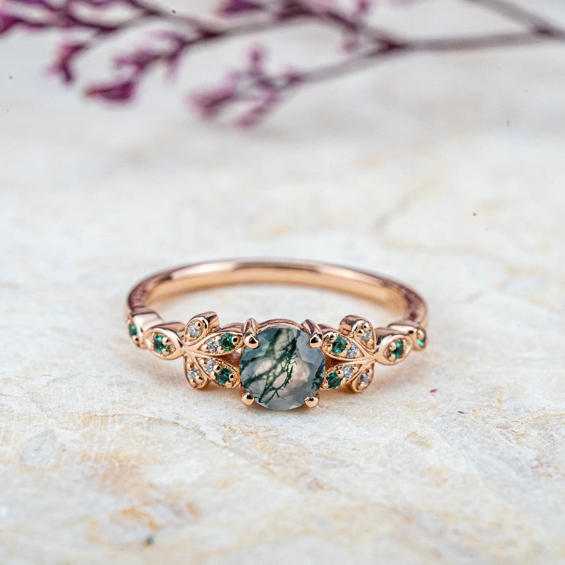 Moss Blossom Ring features a natural moss agate centerpiece with petal-inspired designs and sparkling moissanite accents. A perfect blend of elegance and nature, ideal for daily wear or as a meaningful gift