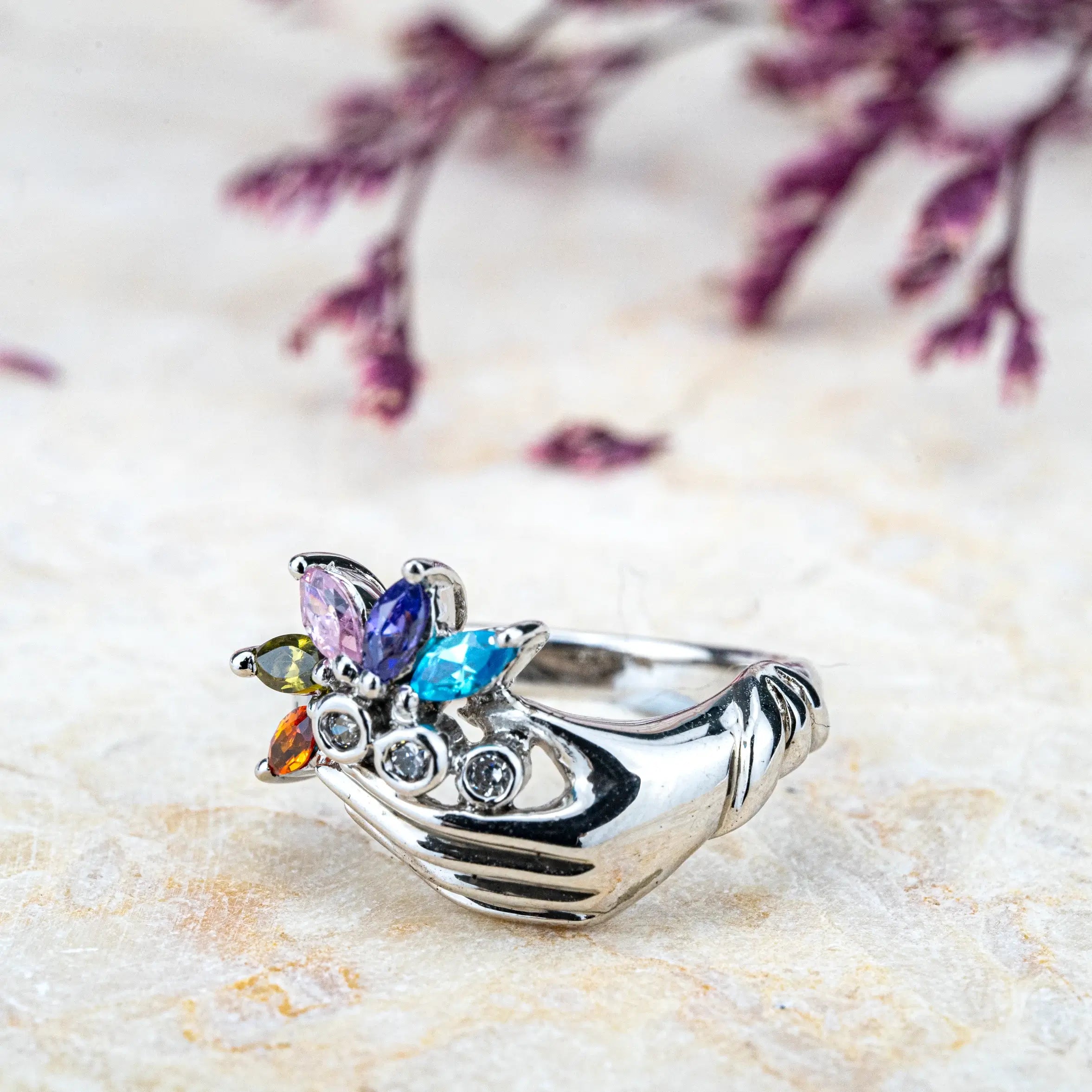 White Gold Hand Holding Colorful Gemstone Flower Ring – Artistic Statement