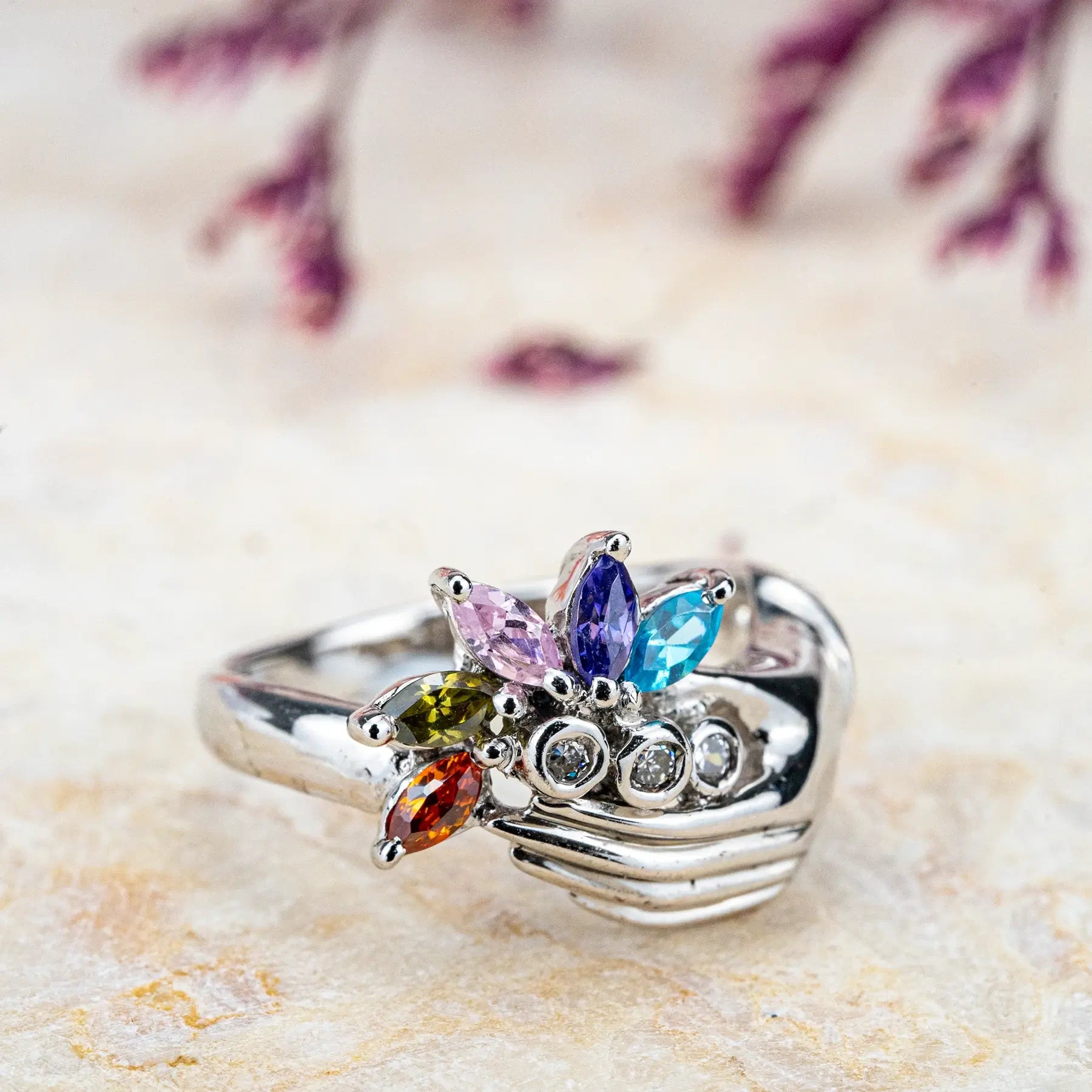 White Gold Hand Holding Colorful Gemstone Flower Ring – Artistic Statement
