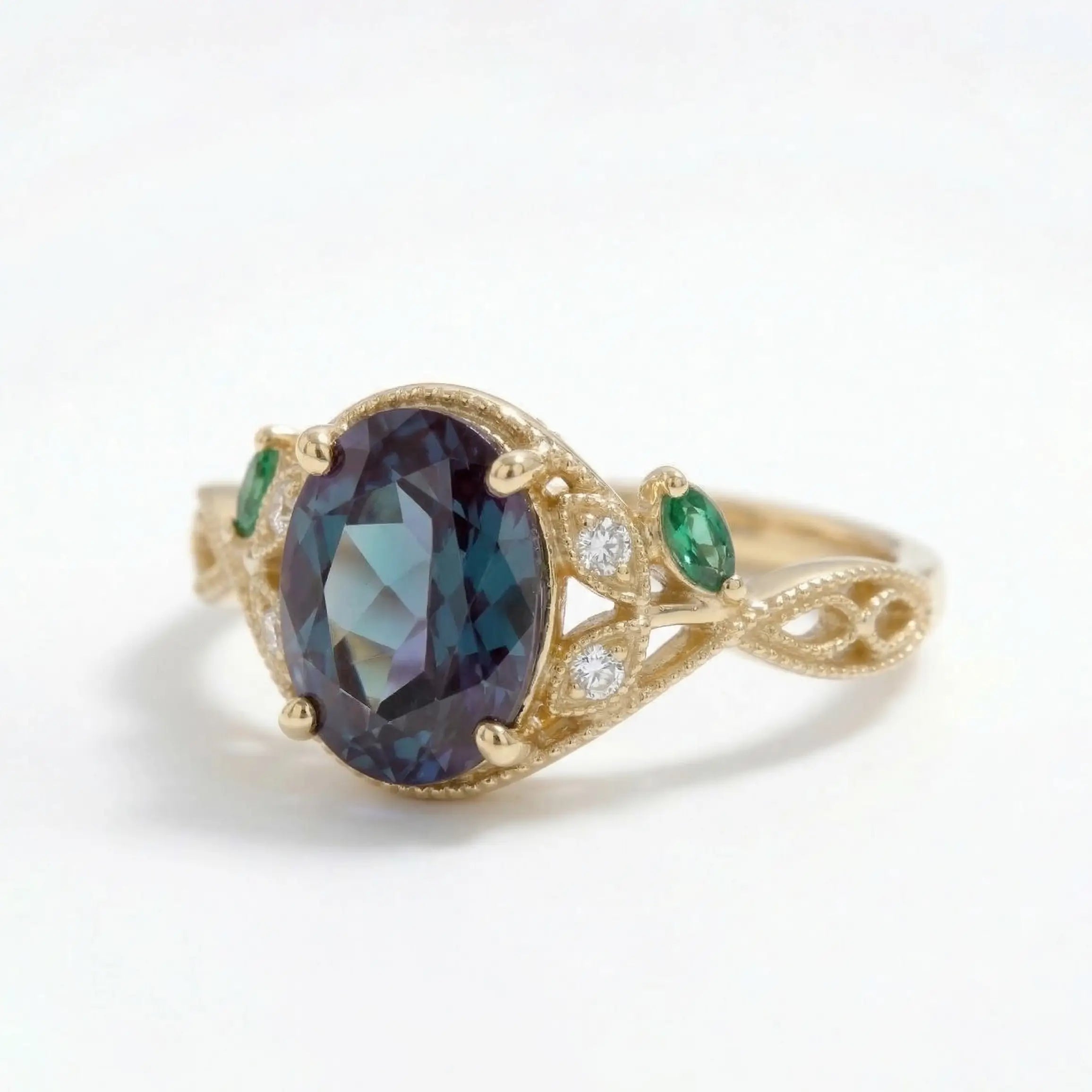 oval lab emerald engagement ring with edwardian filigree leaf band and marquise emerald side stones