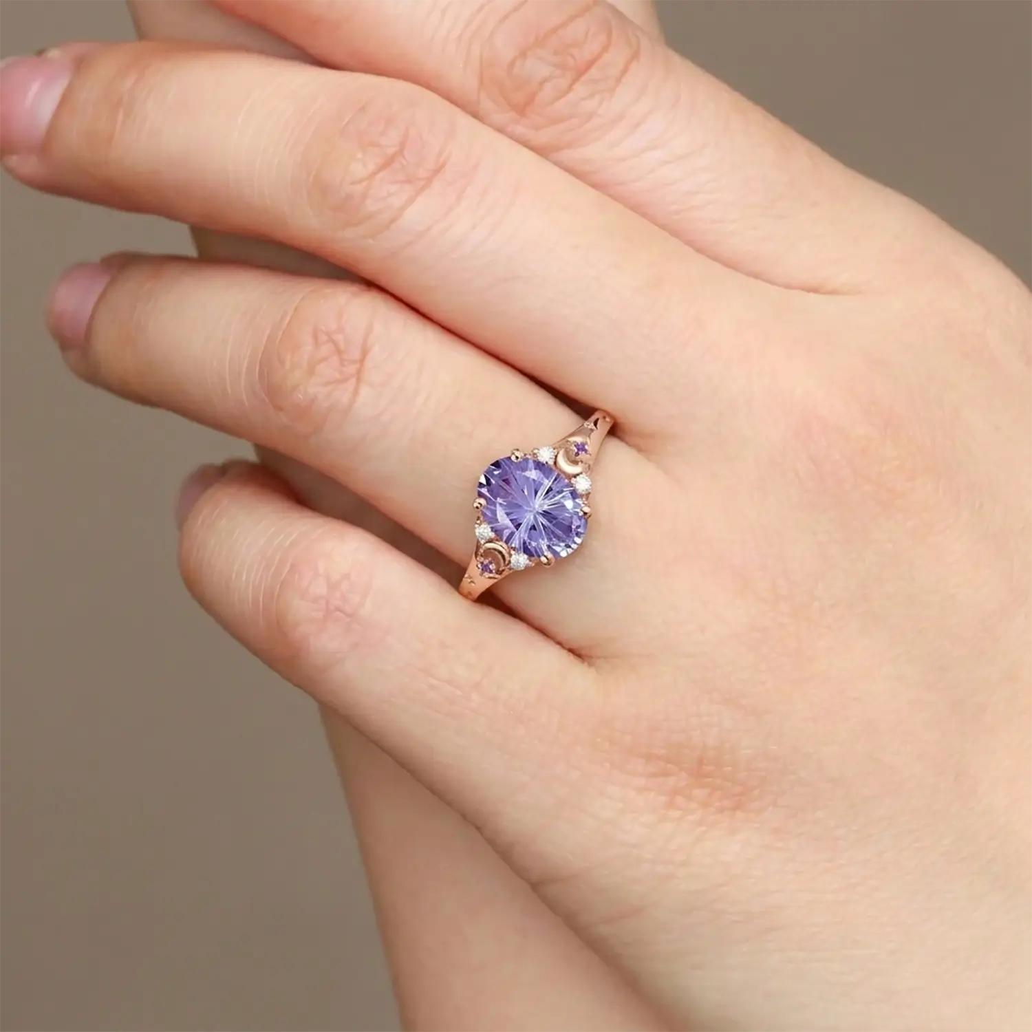Woman wearing alexandrite moon engagement ring in rose gold 14k