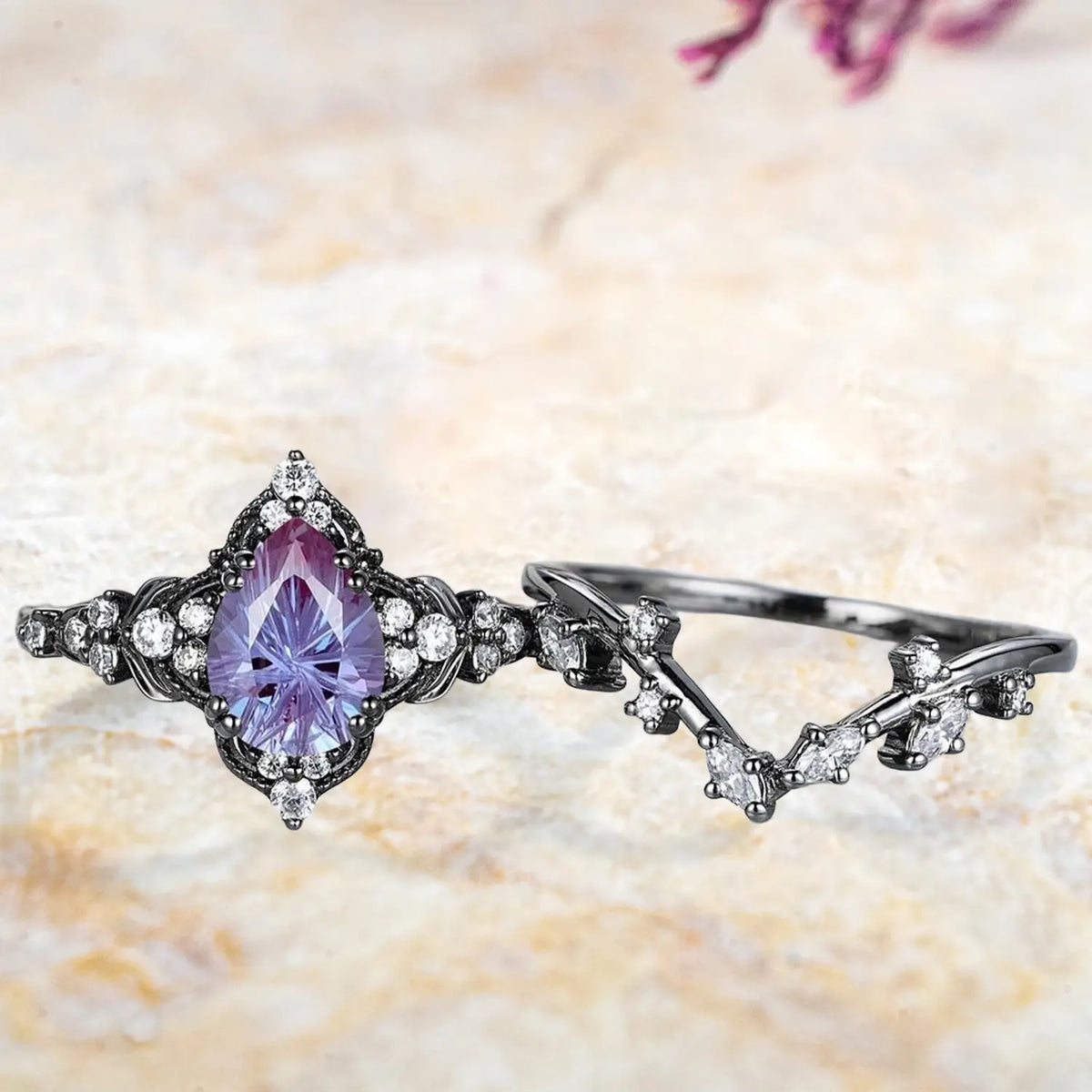 Pear alexandrite fireworks cluster engagement ring and chevron wedding band displayed separately showing unique June birthstone bridal set