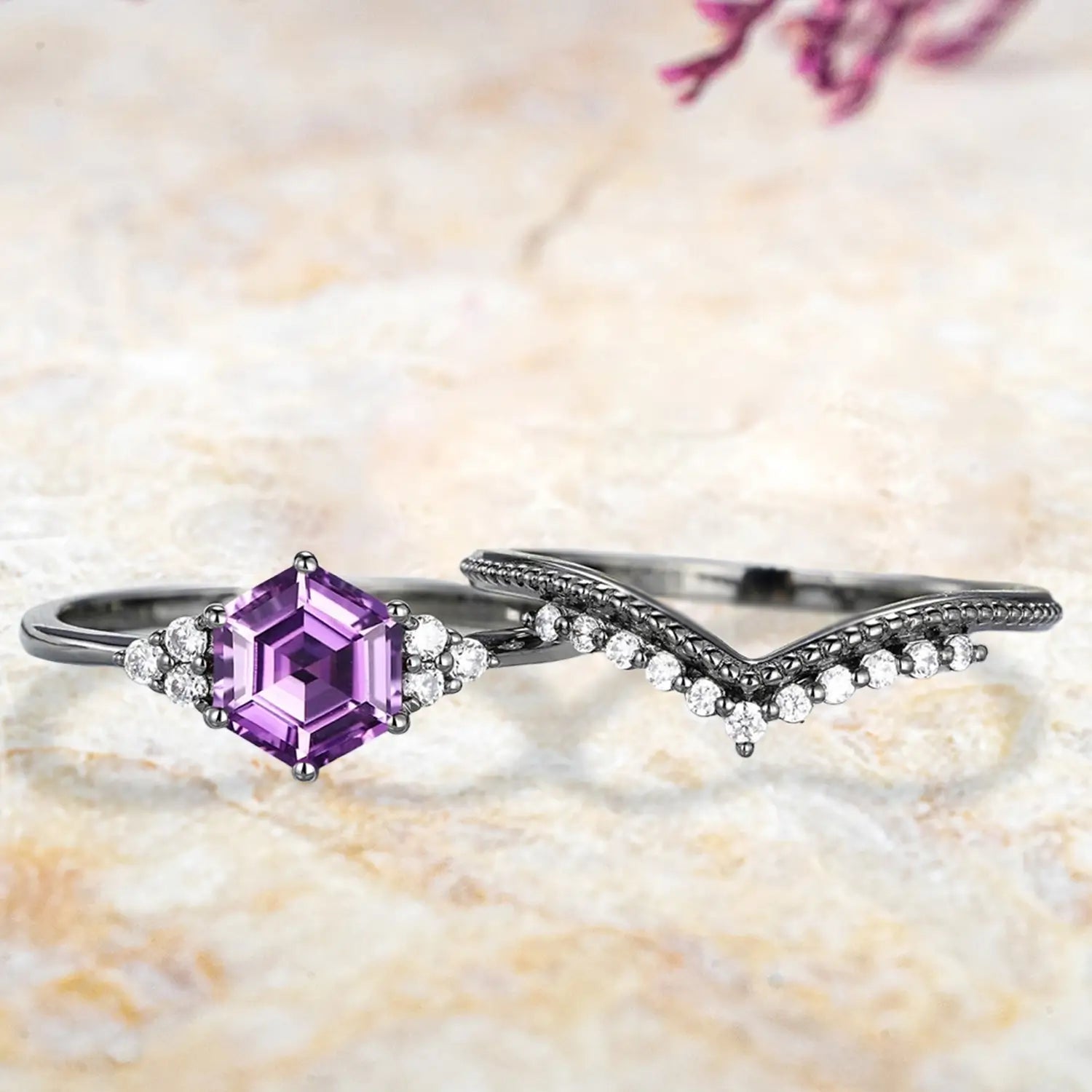 Hexagon amethyst cluster engagement ring and milgrain chevron wedding band displayed separately showing February birthstone bridal set