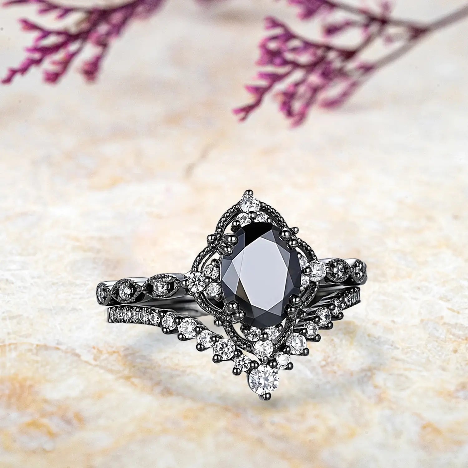 Side view of oval black onyx ring showing vintage crown cluster halo and chevron wedding band profile