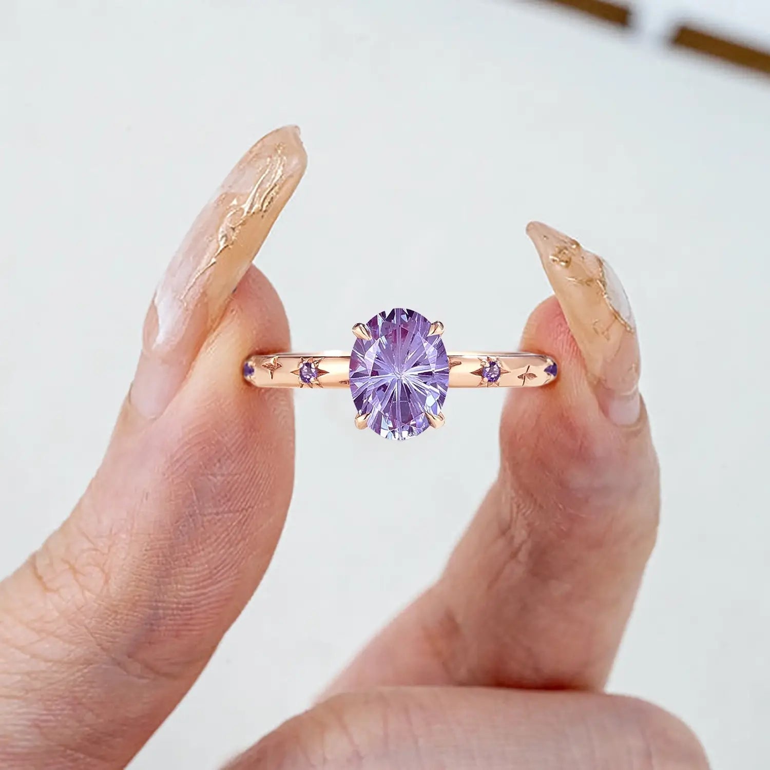 Woman wearing alexandrite starburst engagement ring in rose gold | orleone