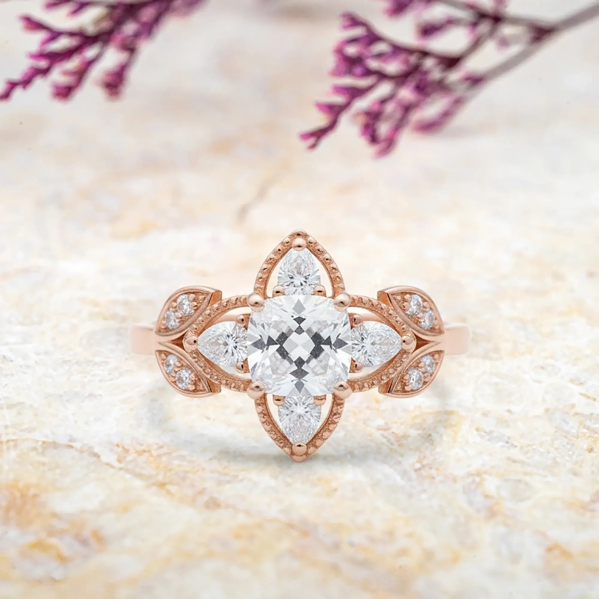 Cushion moissanite engagement ring with four leaf clover pear halo and vintage milgrain details in rose gold