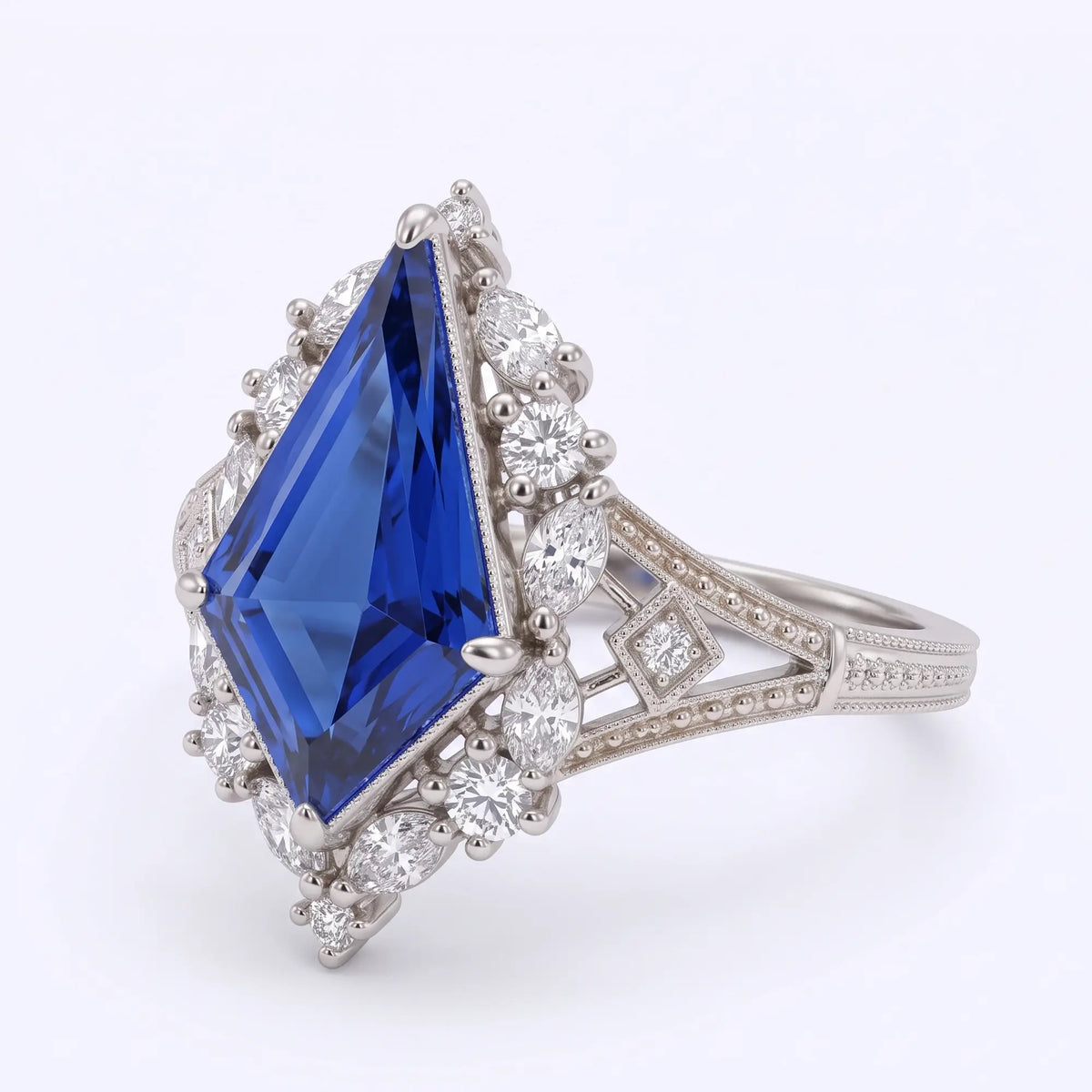 Left angled view of Elarisse kite cut lab sapphire engagement ring showing the vintage geometric cluster setting, delicate milgrain and openwork shoulder.