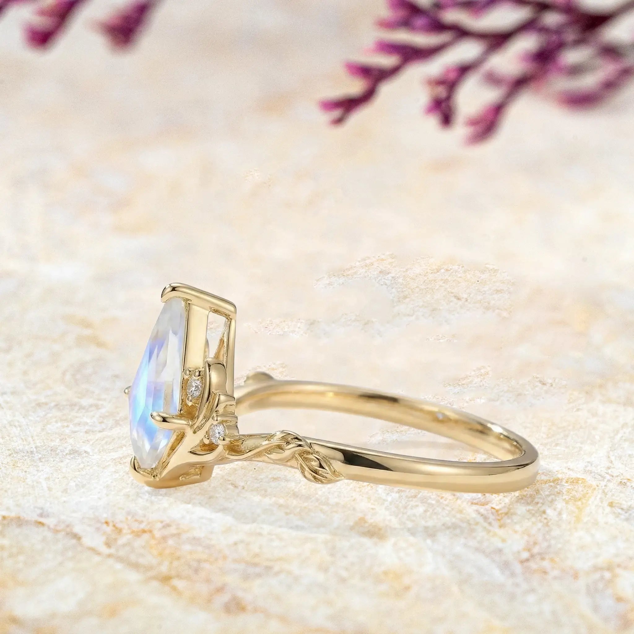 Side view of kite cut moonstone engagement ring showing stag antler setting and leaf band detail