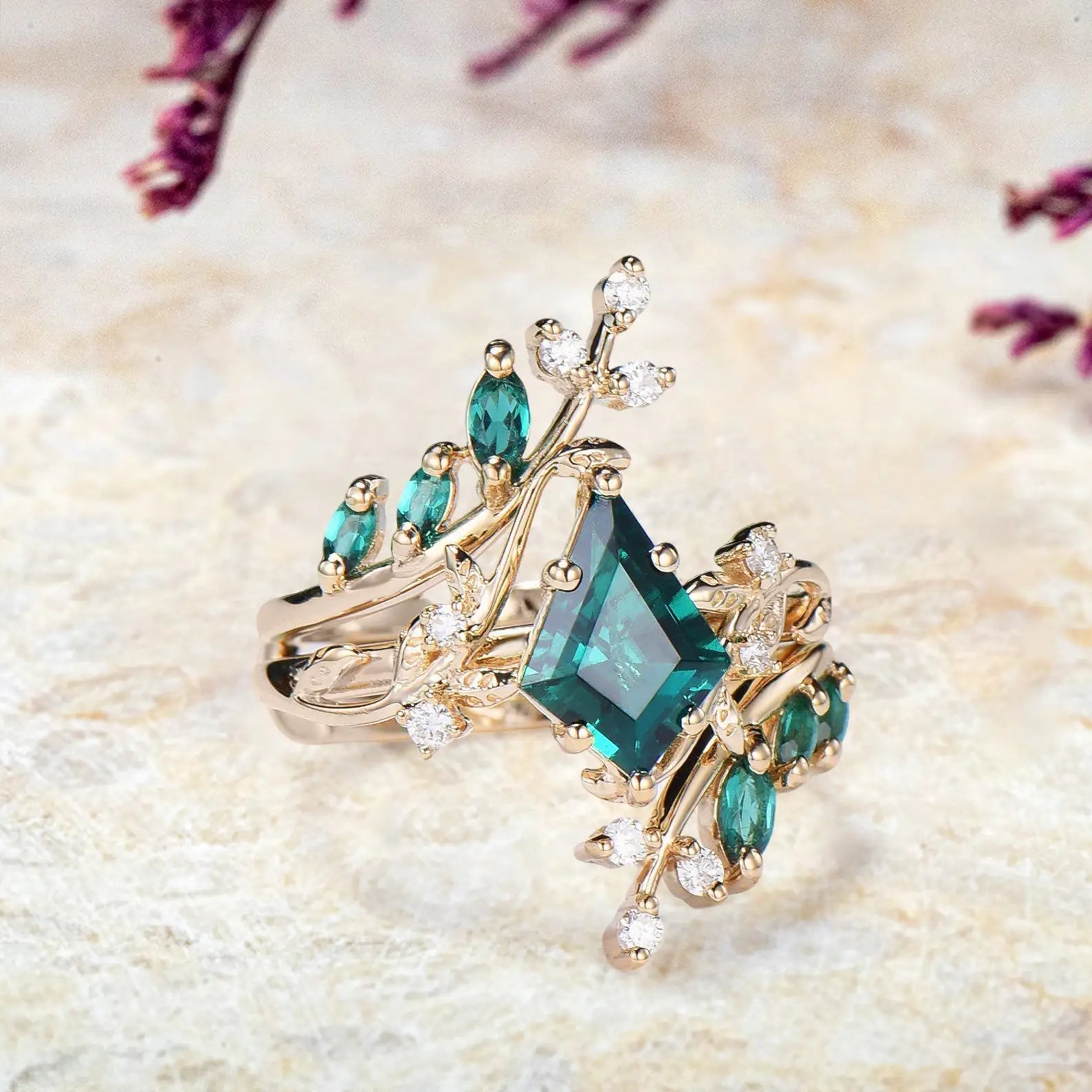 Side view of emerald bridal set showing yellow gold vine branches and marquise stones