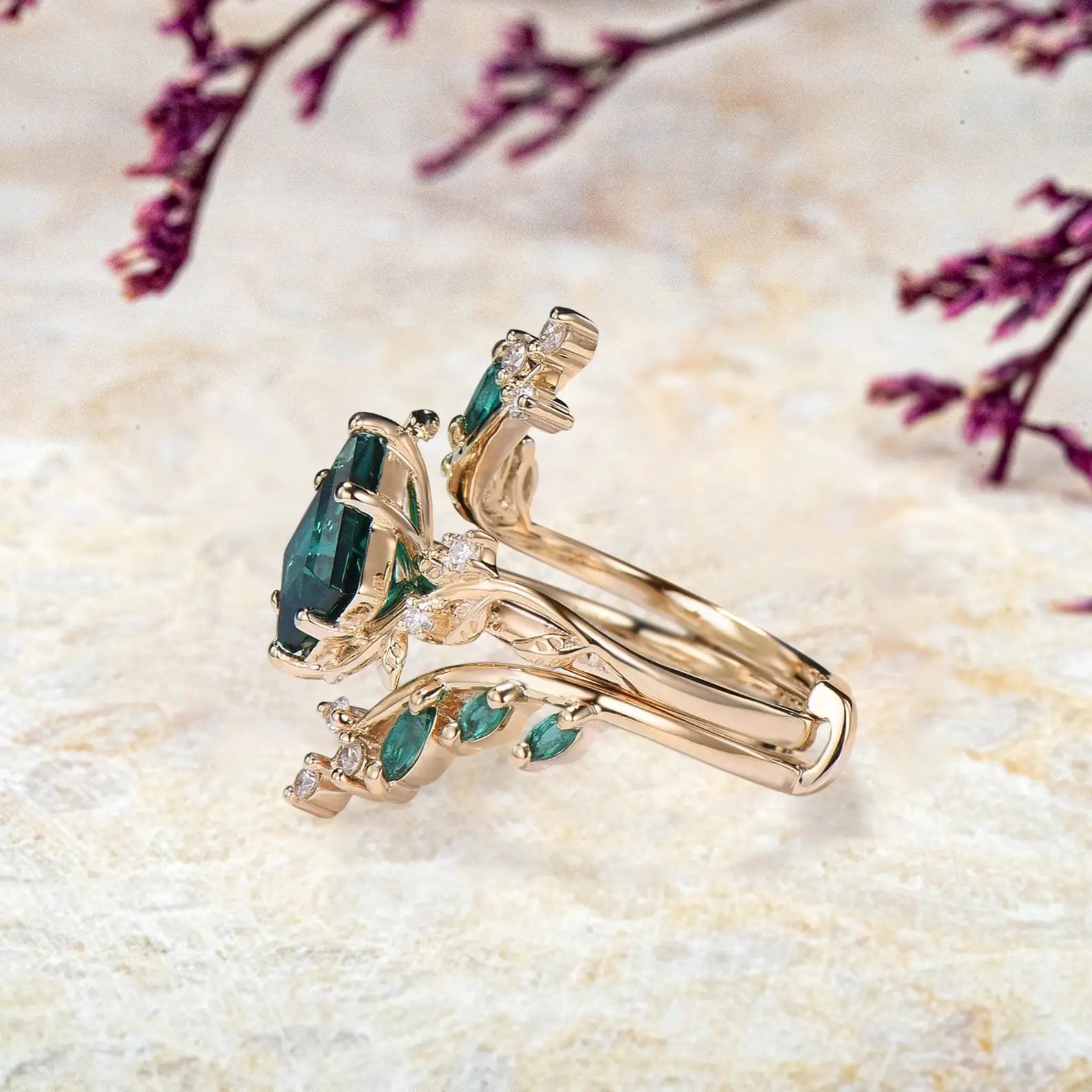 Side view of emerald bridal set showing yellow gold vine branches and marquise stones
