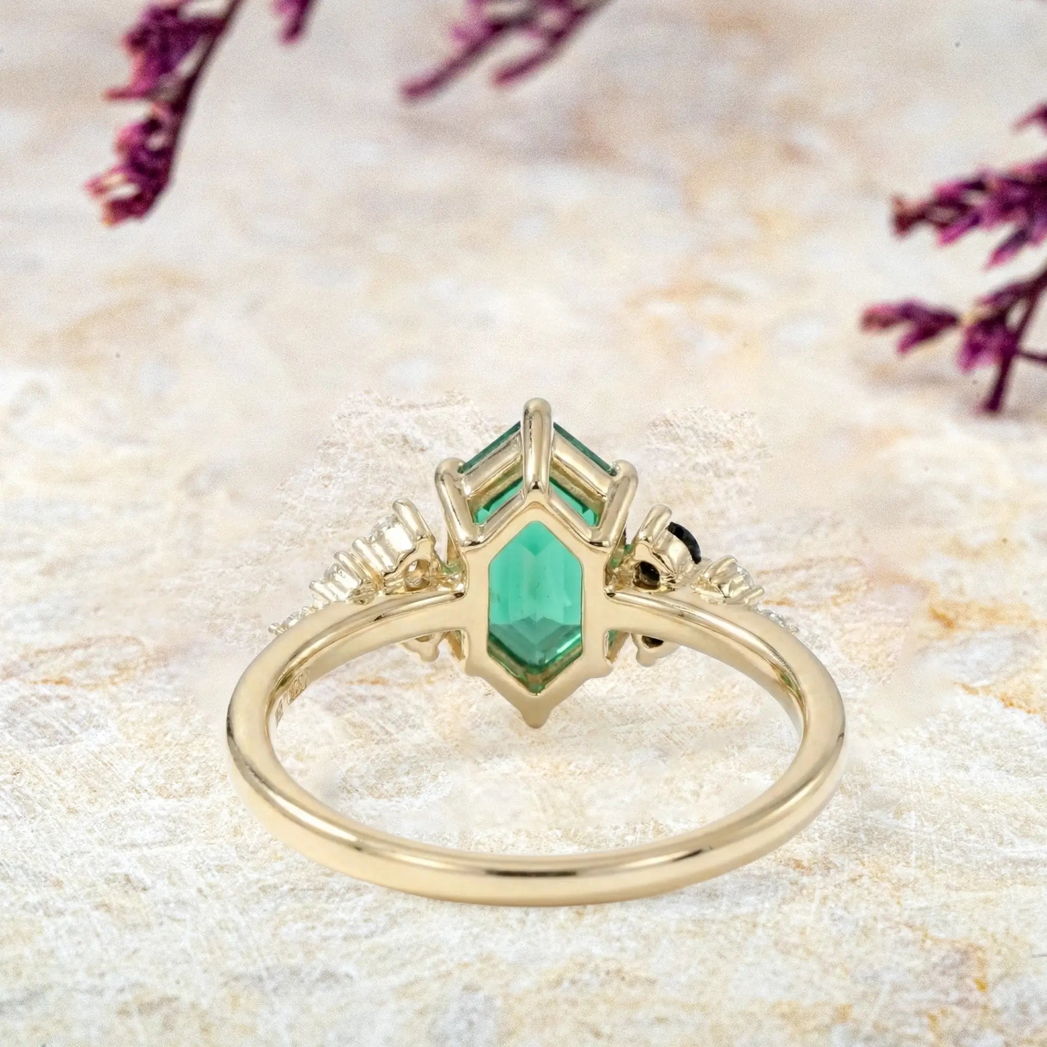 Close-up of long hexagon emerald ring highlighting moissanite and onyx cluster back view