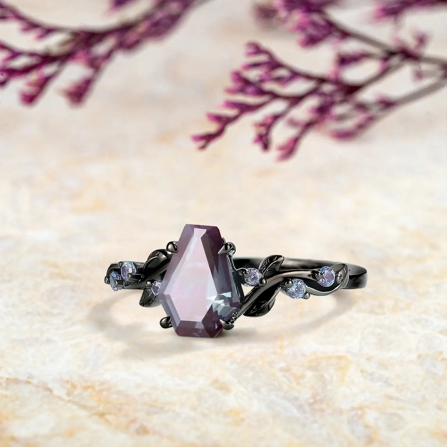 Side view of coffin alexandrite ring showing leaf details and black gold band profile