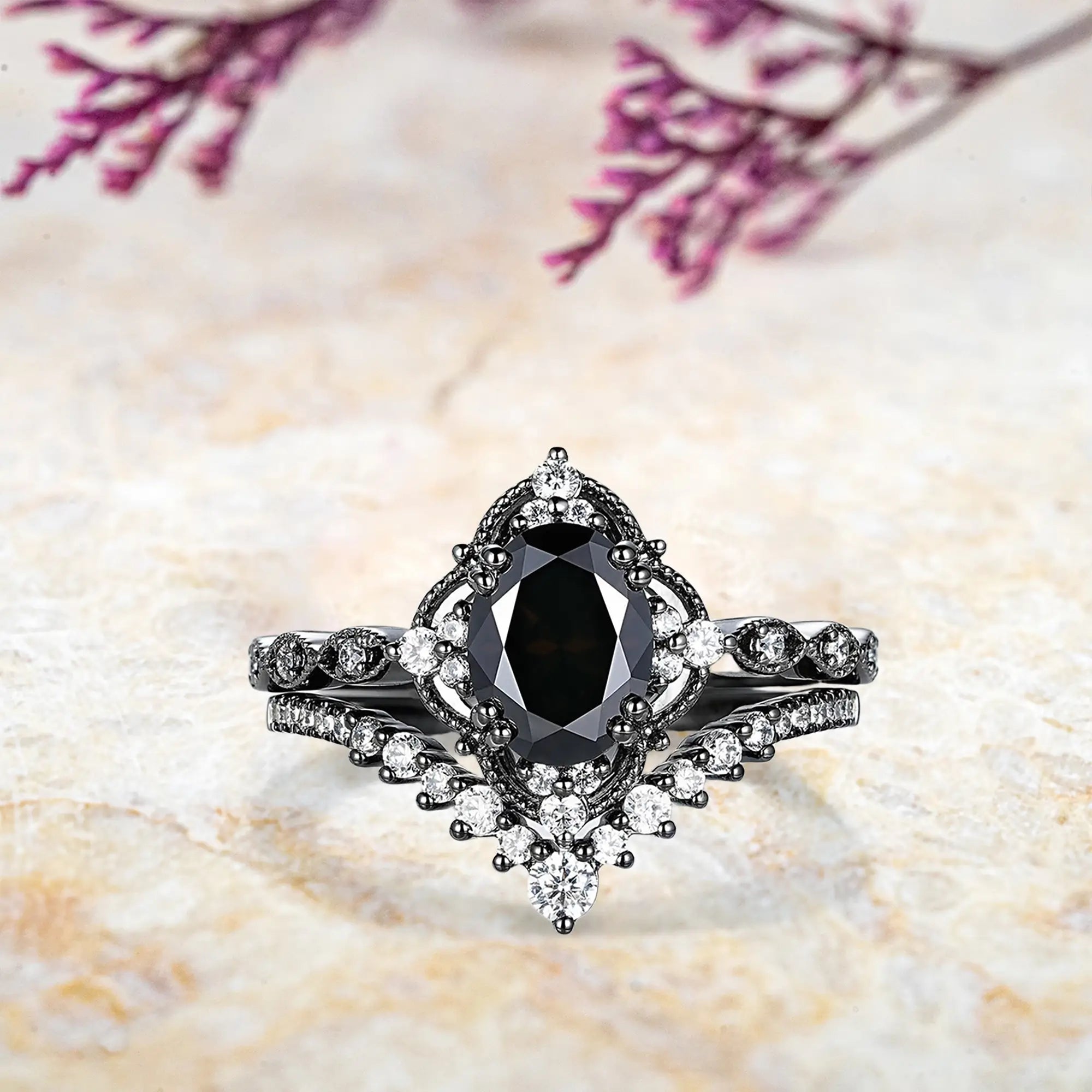 Oval black onyx engagement ring with vintage crown cluster and chevron diamond wedding band set in black gold
