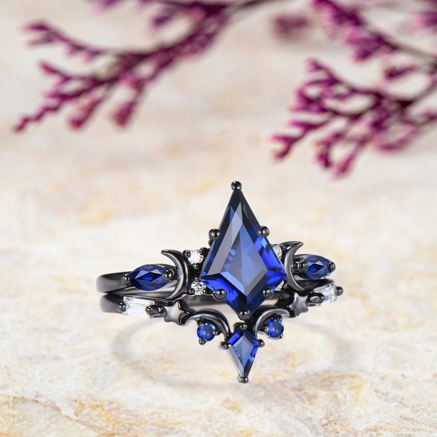 Side profile of kite cut blue sapphire engagement ring in black gold