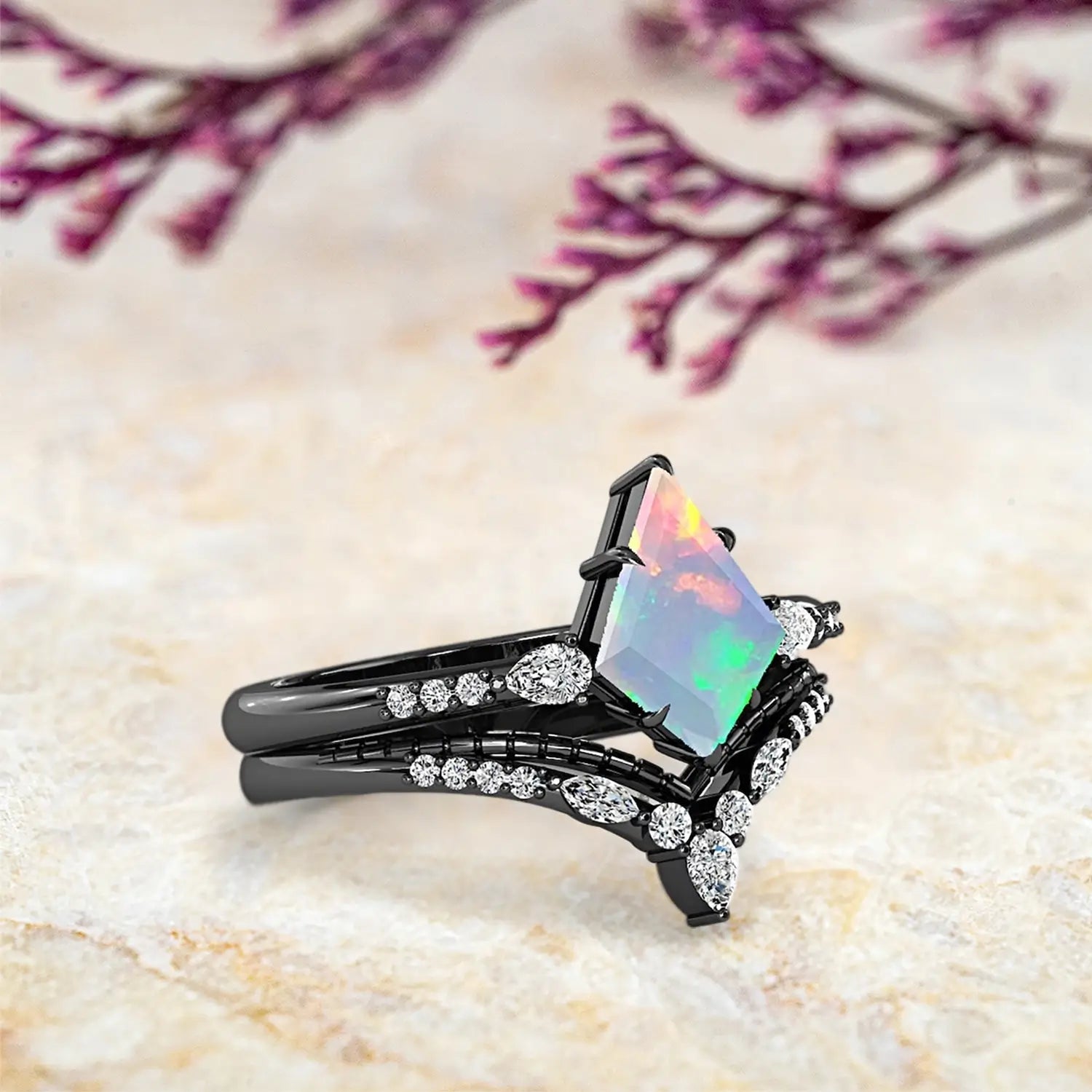 Side view of kite opal ring showing modern art deco design with pear accents and double chevron wedding band profile