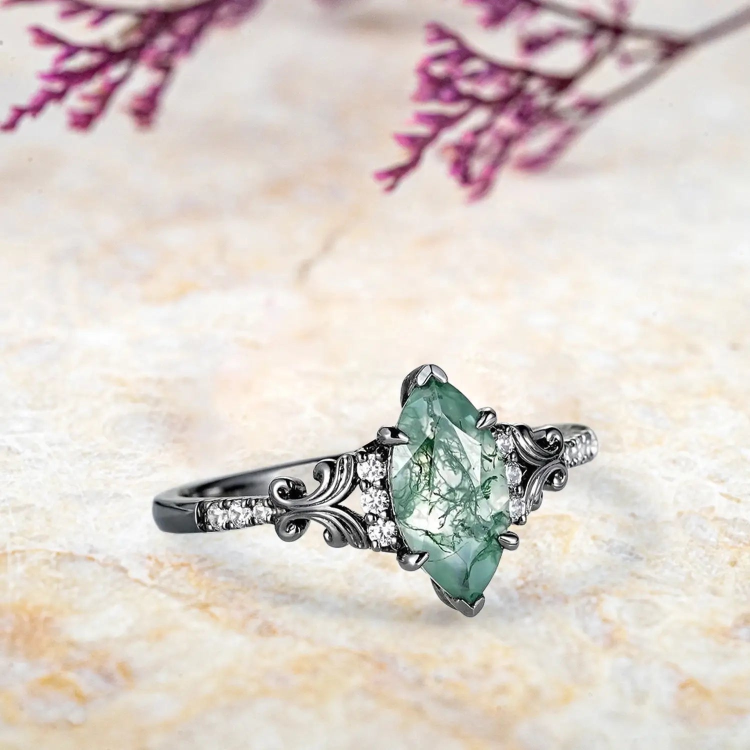 Side view of vintage moss agate engagement ring showing ornate scrollwork and moissanite accents