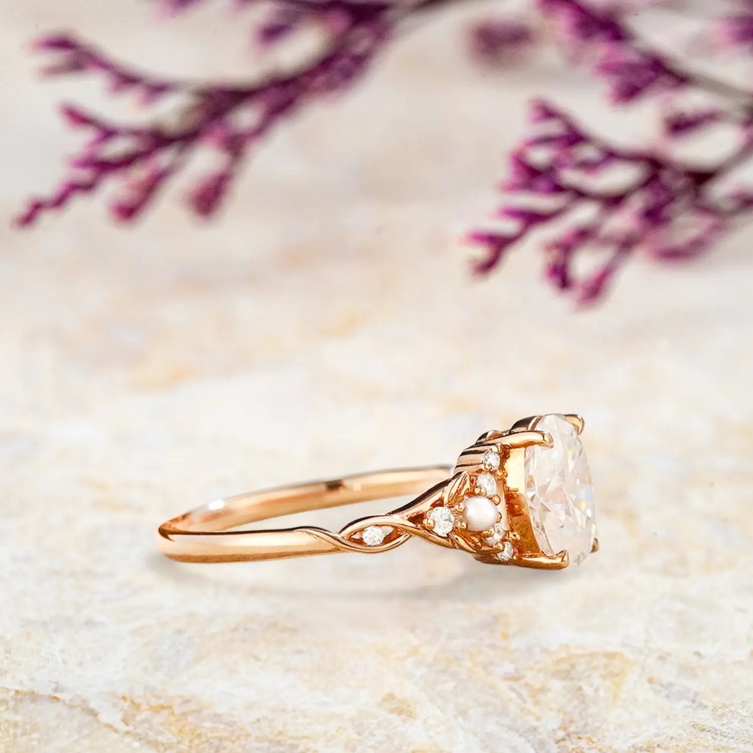 Close up detail of oval moissanite center stone with freshwater pearl and diamond cluster setting