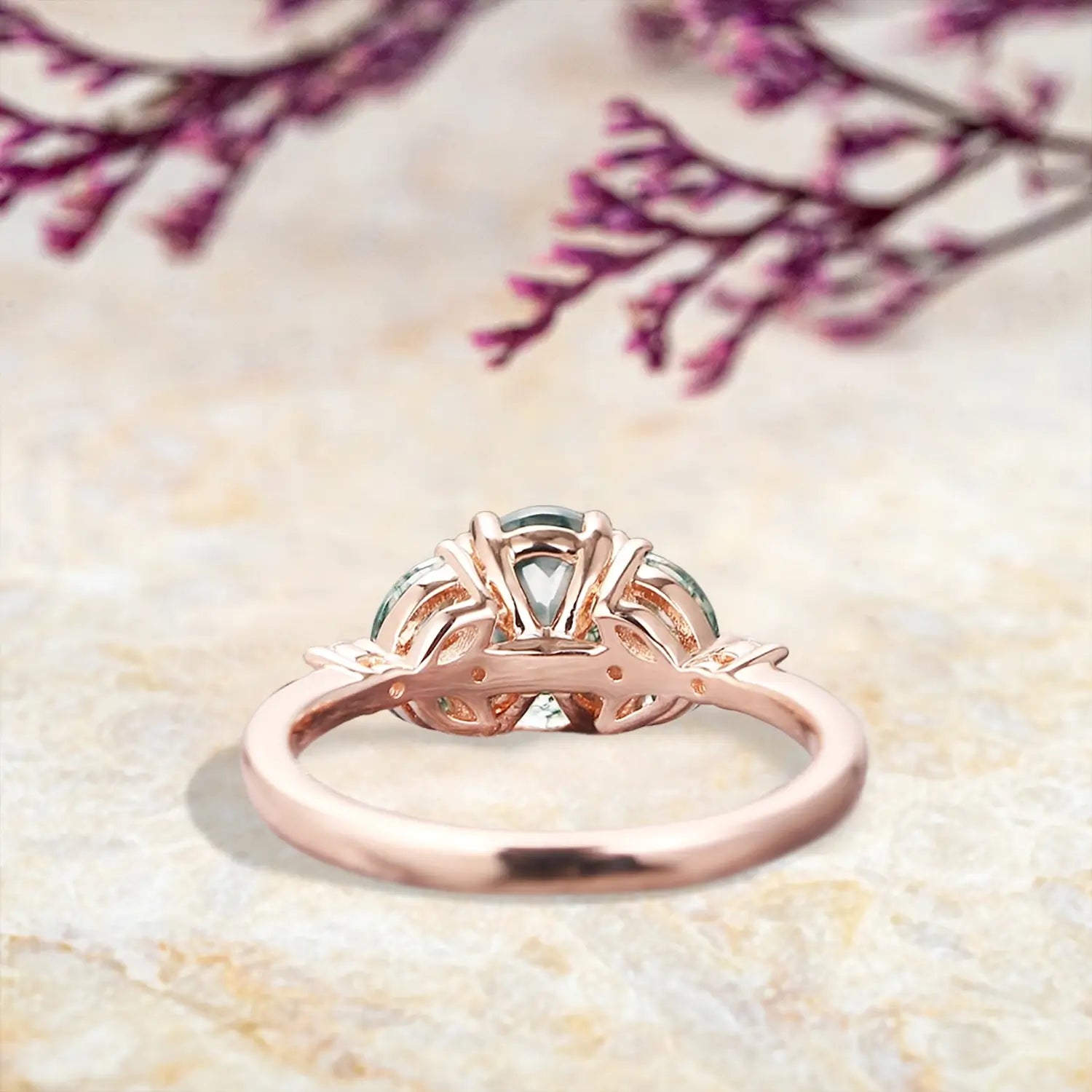 Back view of moss agate engagement ring showing rose gold band and prong details