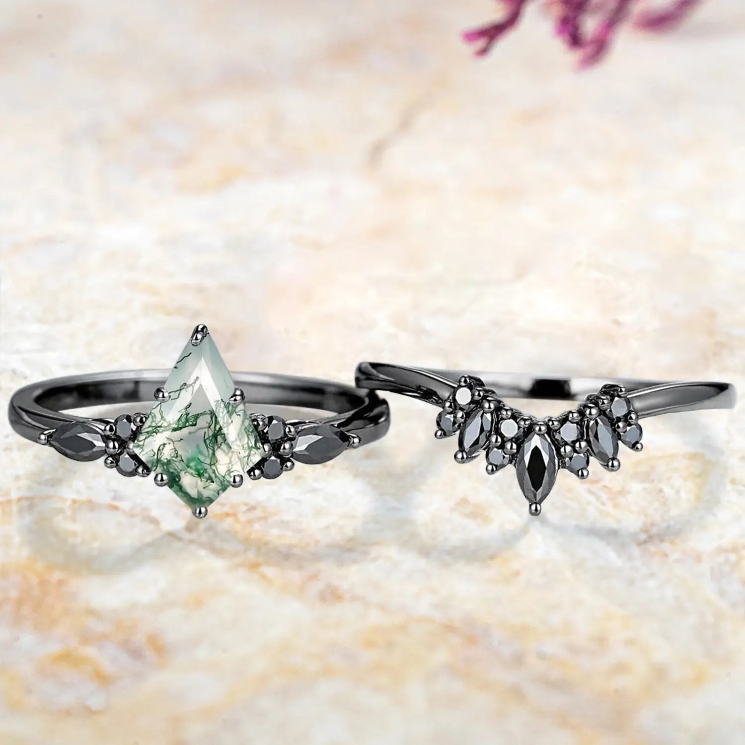 Kite moss agate cluster engagement ring and black onyx chevron wedding band displayed separately showing unique Gothic bridal set