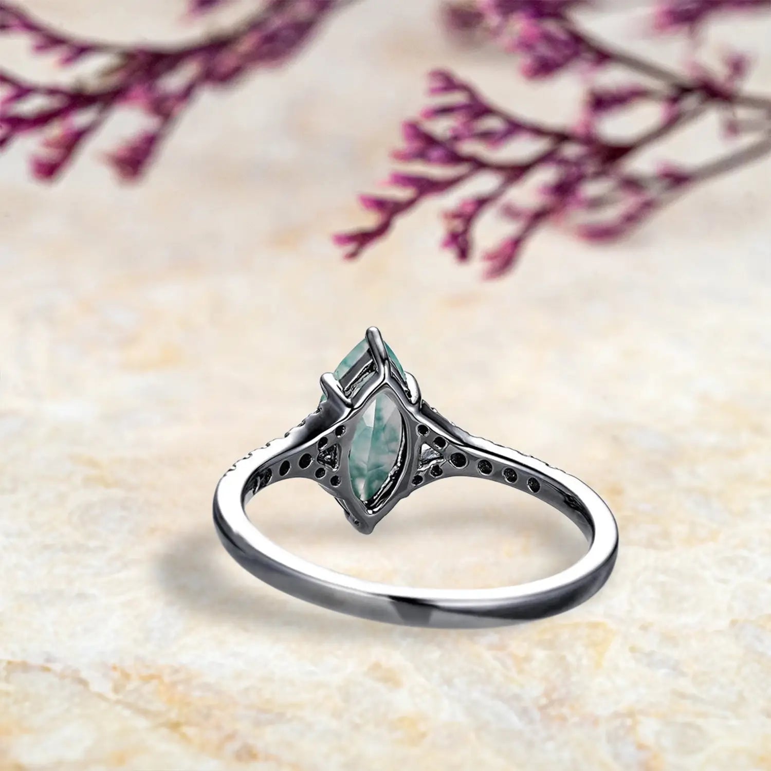 Back view of vintage moss agate engagement ring showing nature inspired split shank band craftsmanship in black gold