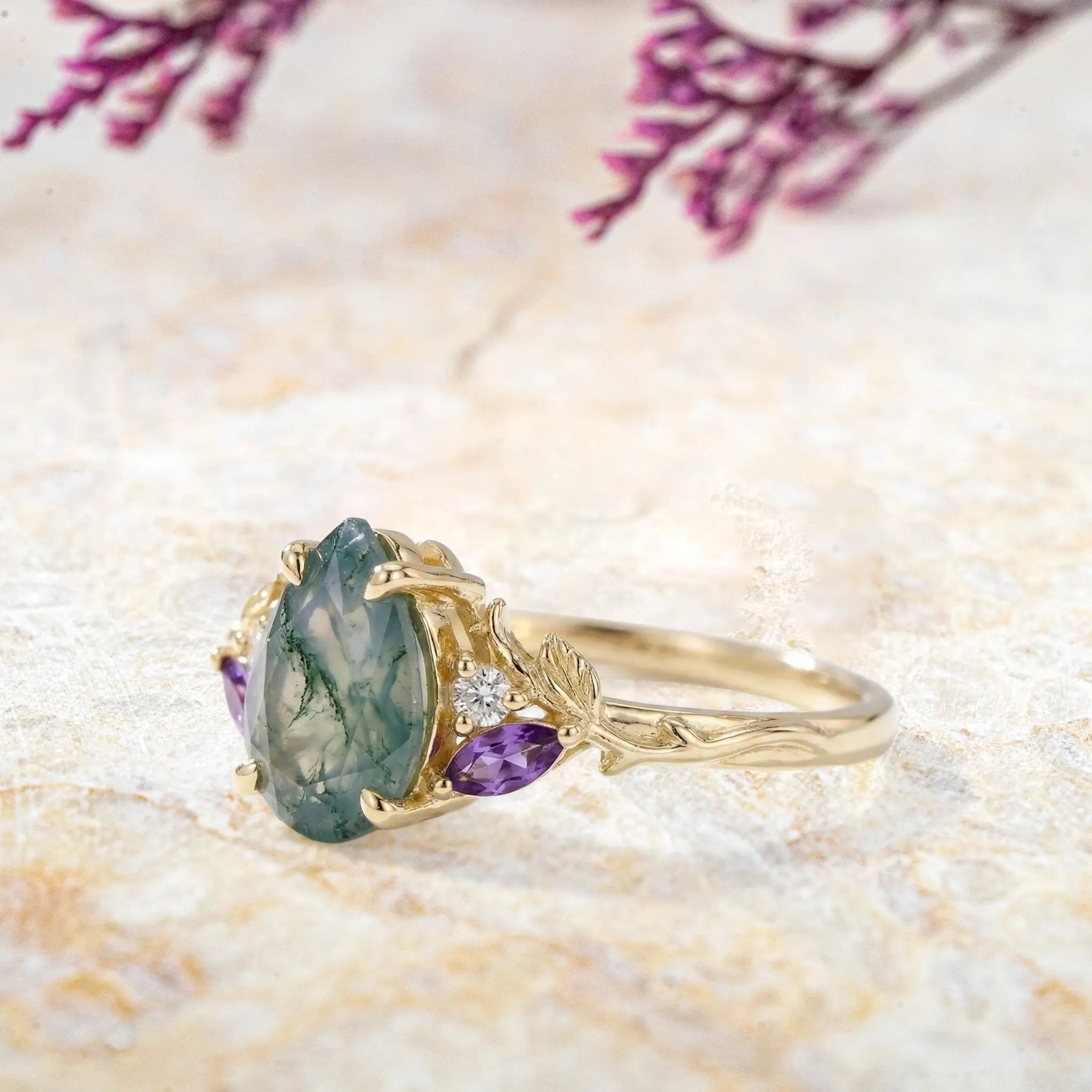 Side view of pear moss agate ring showing leaf band and side stones