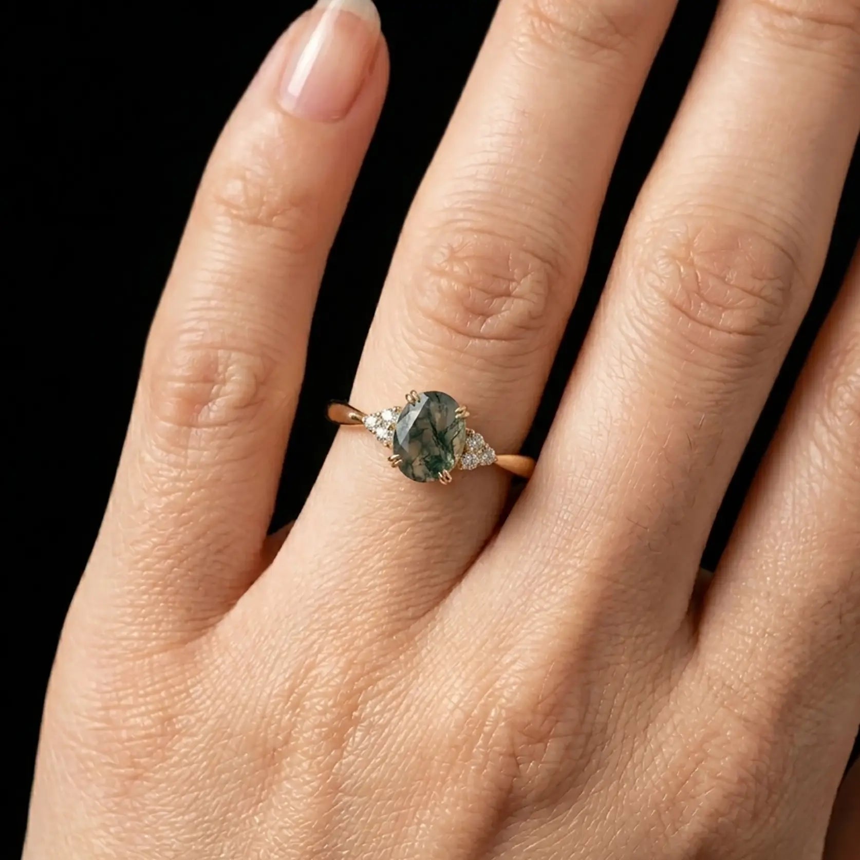 Luminous handmade moss agate cluster ring on hand showing organic botanical patterns