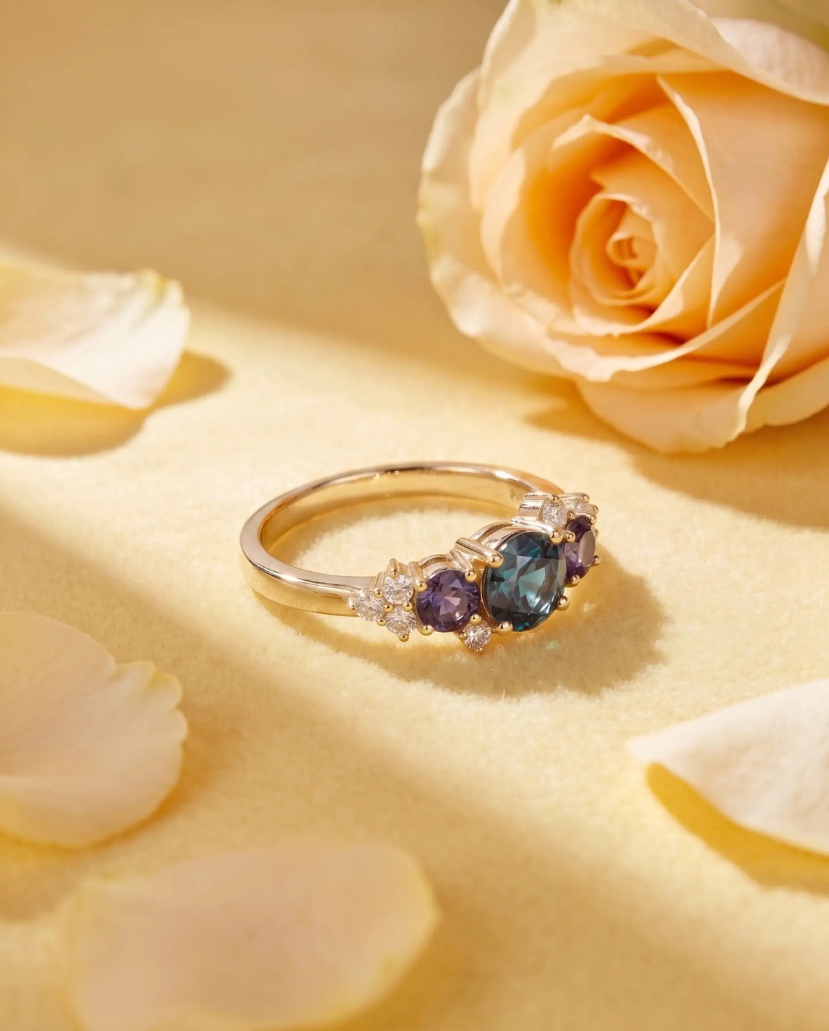 Luxury macro close-up of alexandrite three-stone bridal ring placed in an ethereal high-end setting
