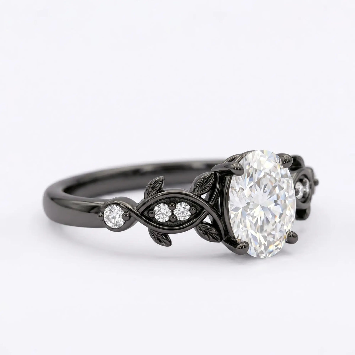 Artisanal dark gold ring featuring oval cut moissanite held by unique decorative organic black rhodium prongs