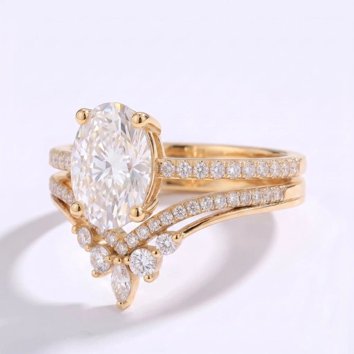 Close-up of oval moissanite center stone with pavé accents in a modern gold bridal set