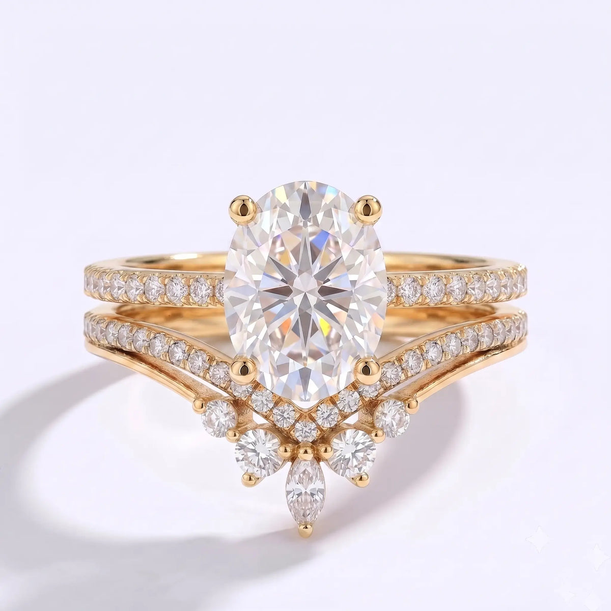 Oval moissanite engagement ring set with a curved V-shaped pavé wedding band in yellow gold