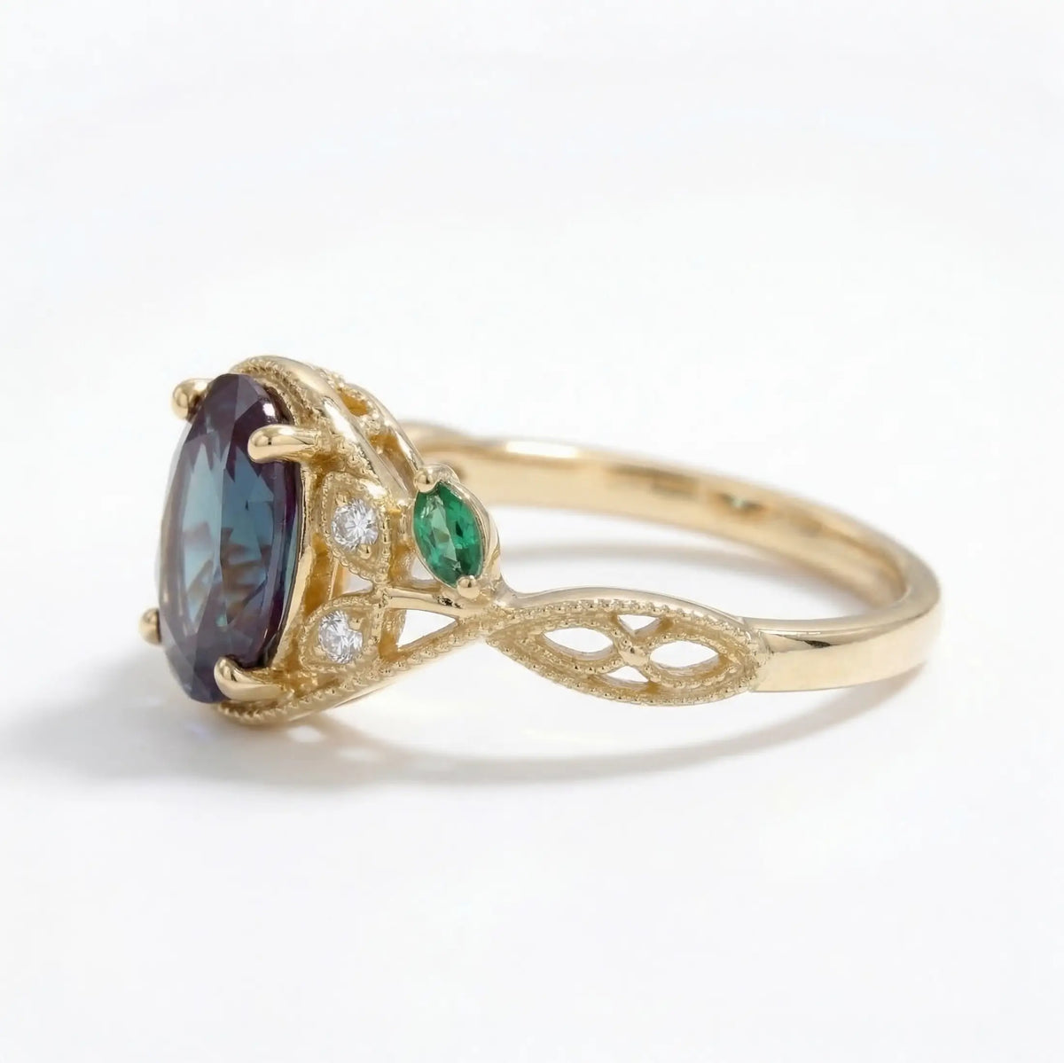 oval emerald engagement ring close up showing milgrain filigree details and vintage leaf design