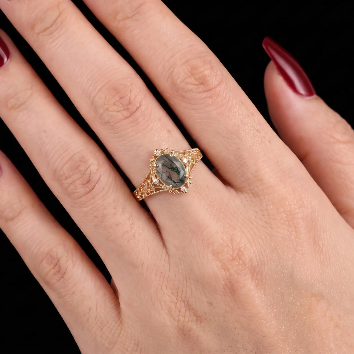 Vintage oval moss agate engagement ring worn on hand custom jewelry