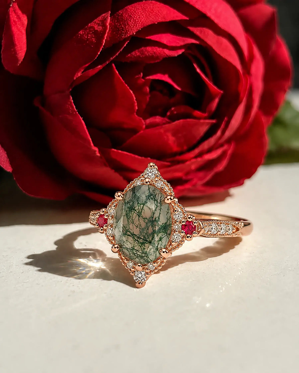Vintage moss agate engagement ring styled in a romantic jewelry setting