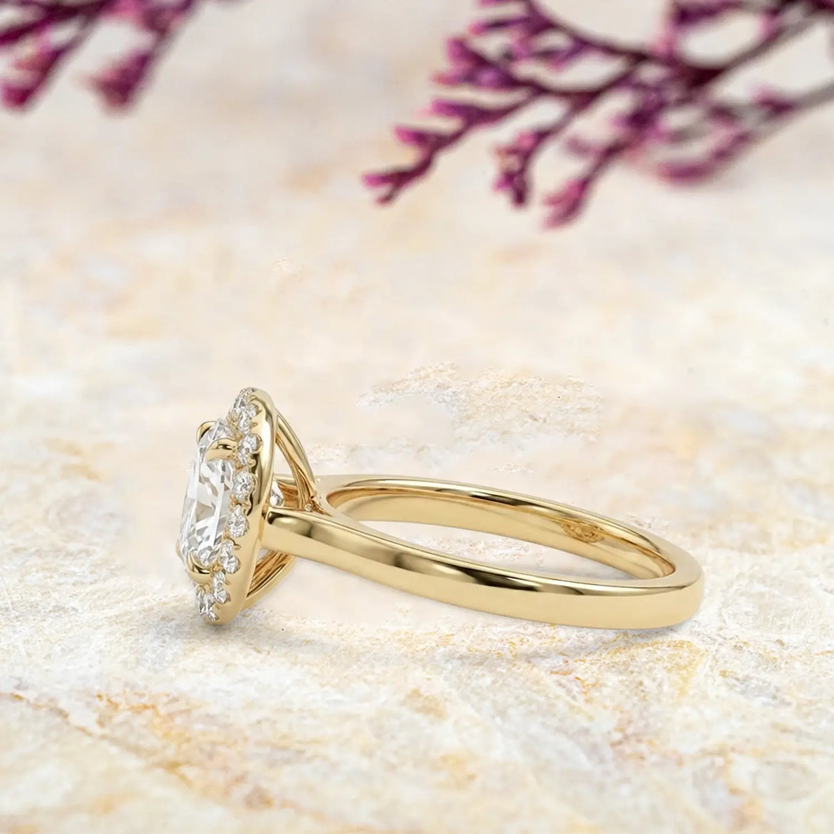Side view of moissanite halo ring showing yellow gold band and pavé details