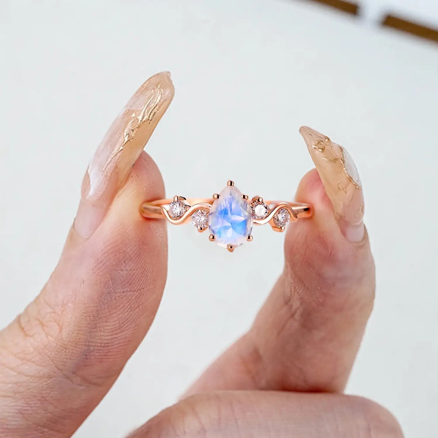 pear-moonstone-engagement-ring-five-stone-rose-gold-twist-band