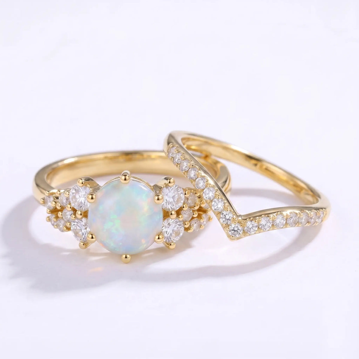 Round opal cluster ring set worn on hand with a matching V-shaped band