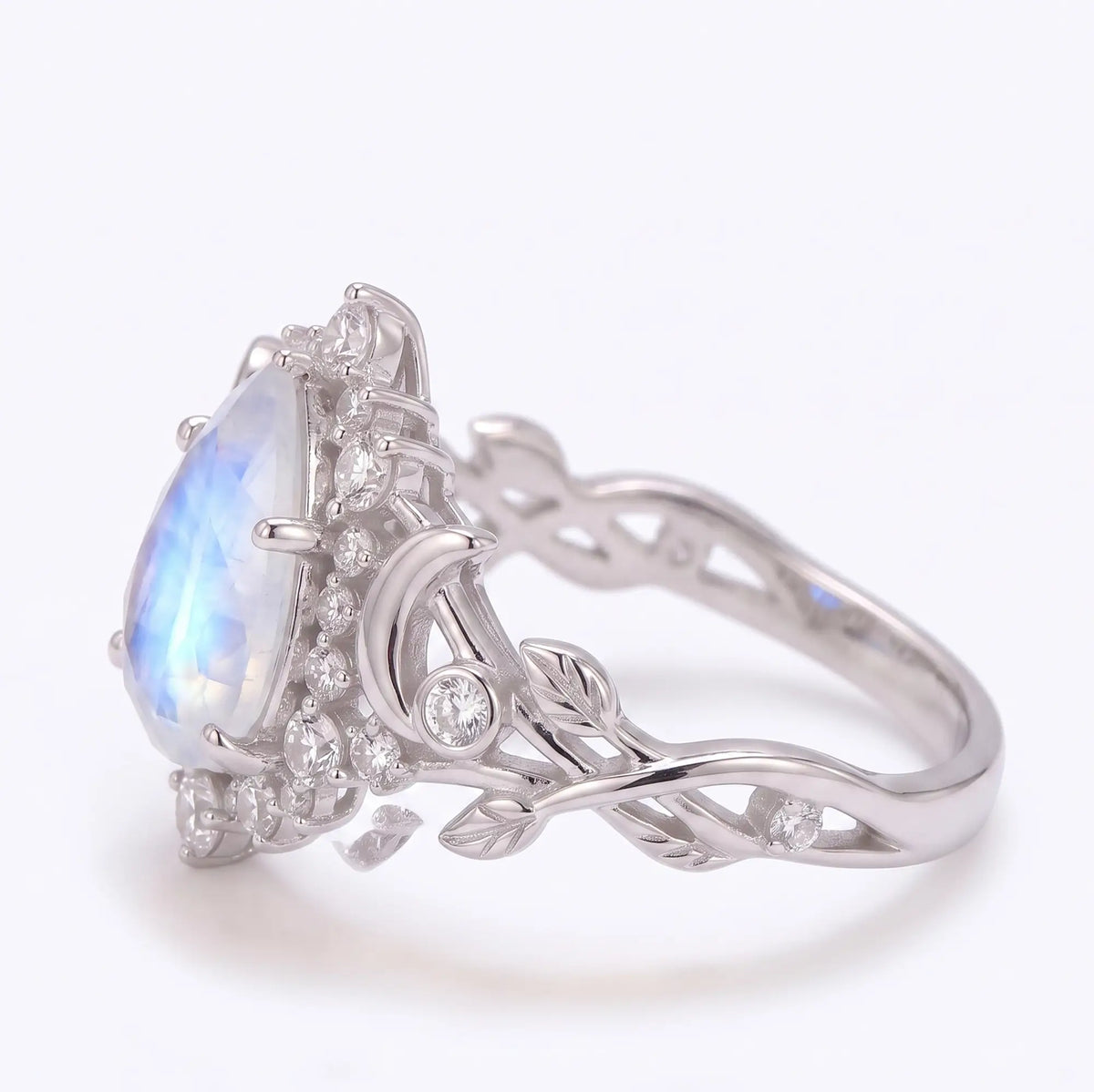 Moonstone halo ring with round moissanite cluster accents