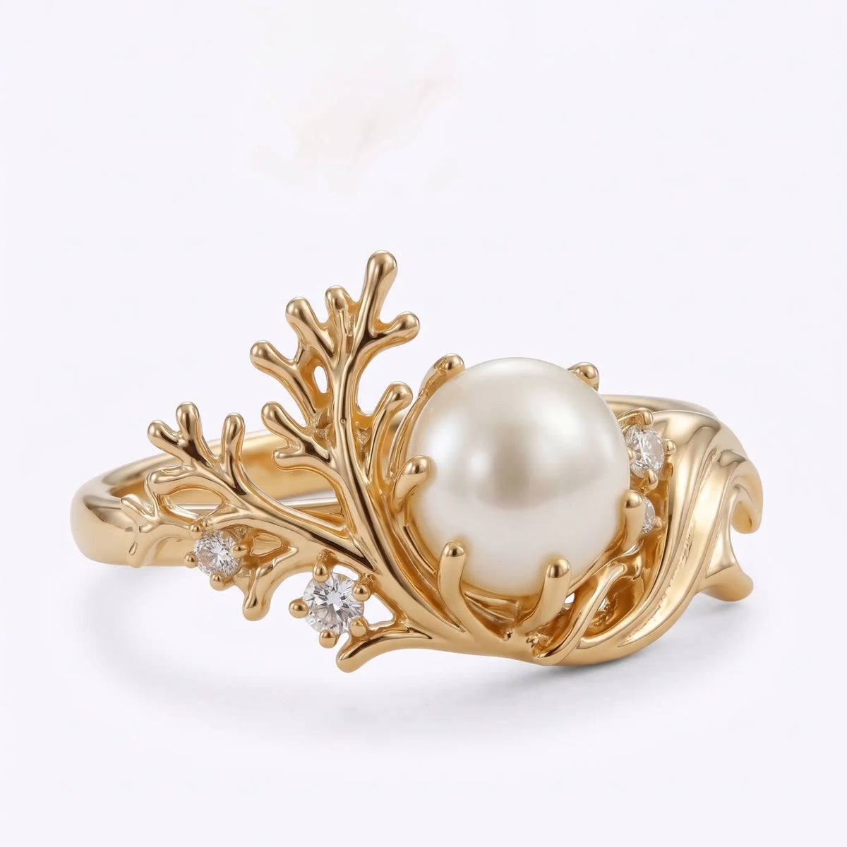 Three quarter view of asymmetrical Akoya pearl ring with coral inspired goldwork