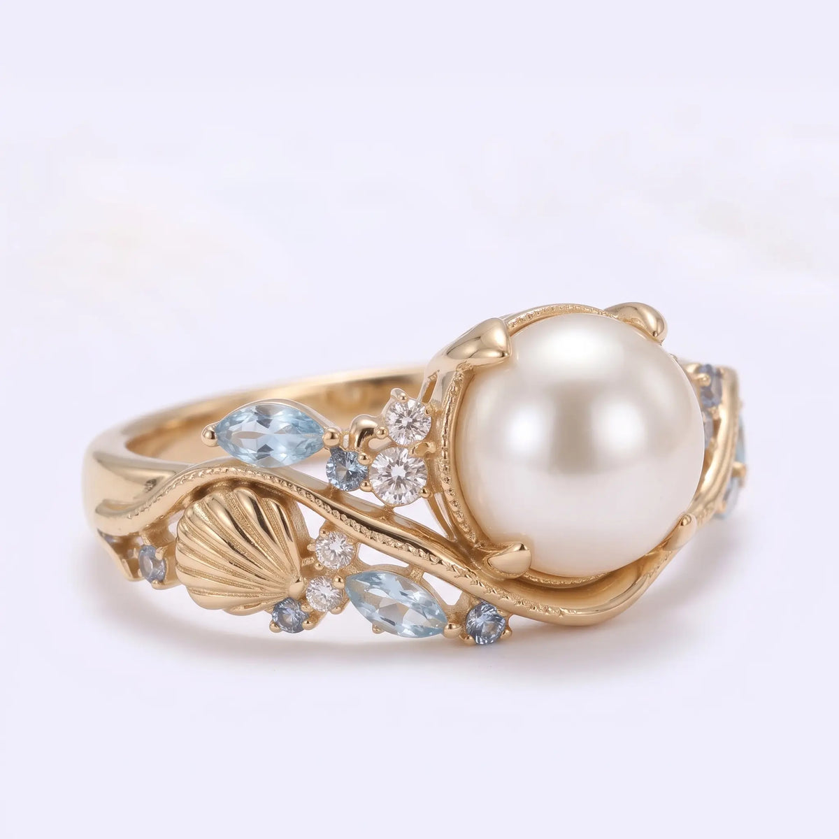 Three quarter view of artistic Akoya pearl cluster ring with marquise aquamarine accents