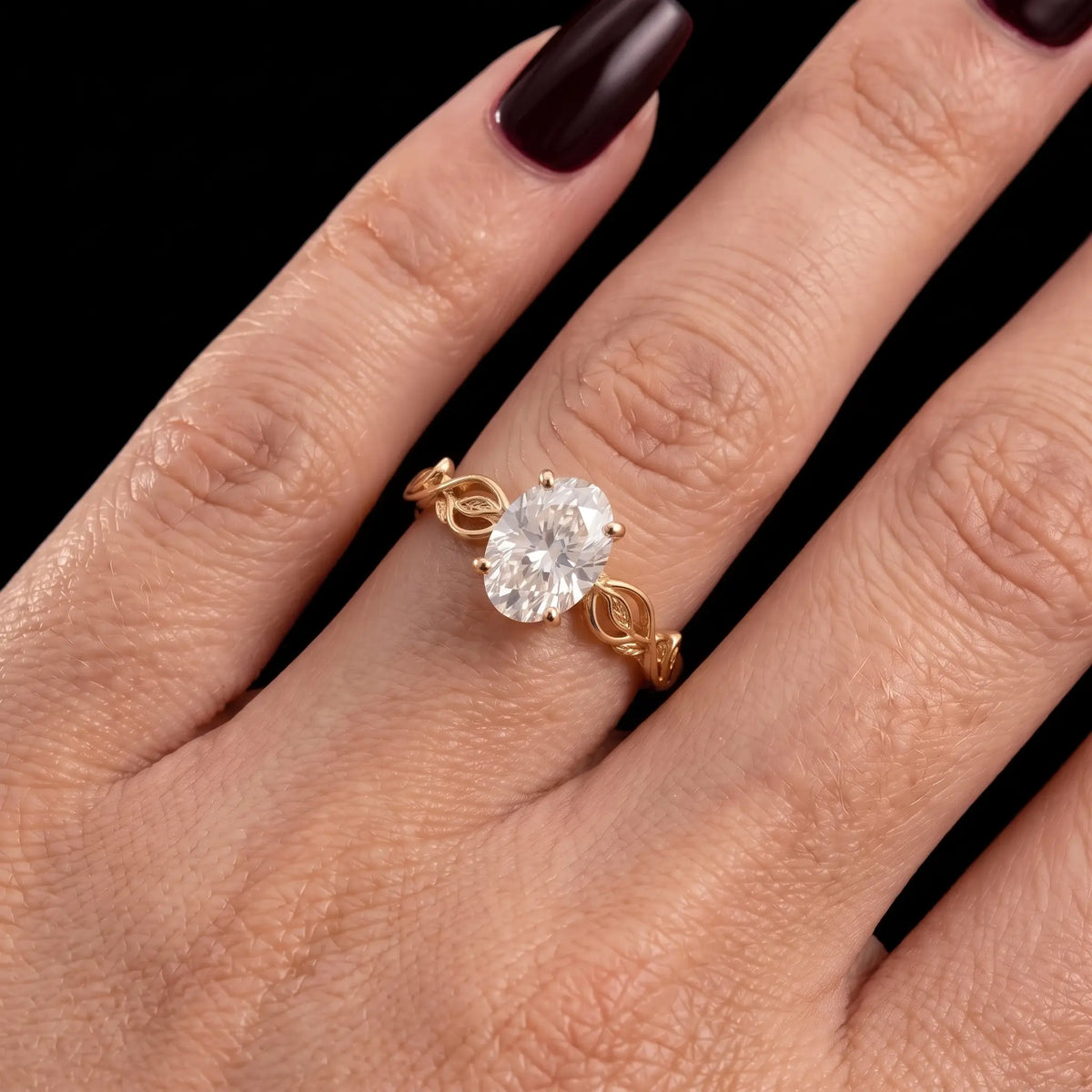 Oval lab-grown diamond leaf vine engagement ring worn on hand