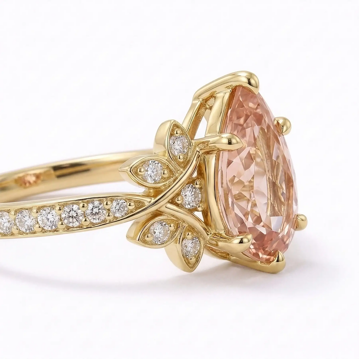 Close-up detail of pear cut morganite center stone with round cluster accents