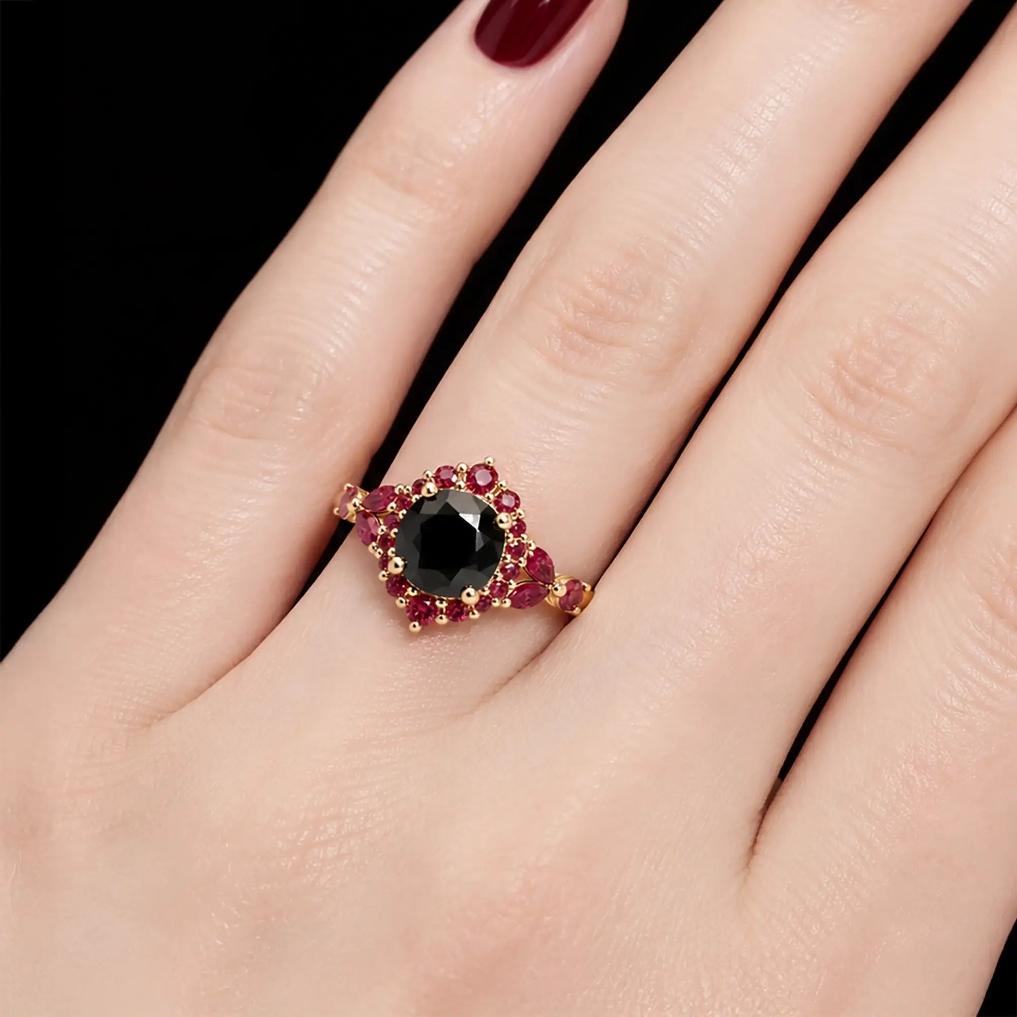 Round black moissanite halo ring worn on hand with ruby floral details