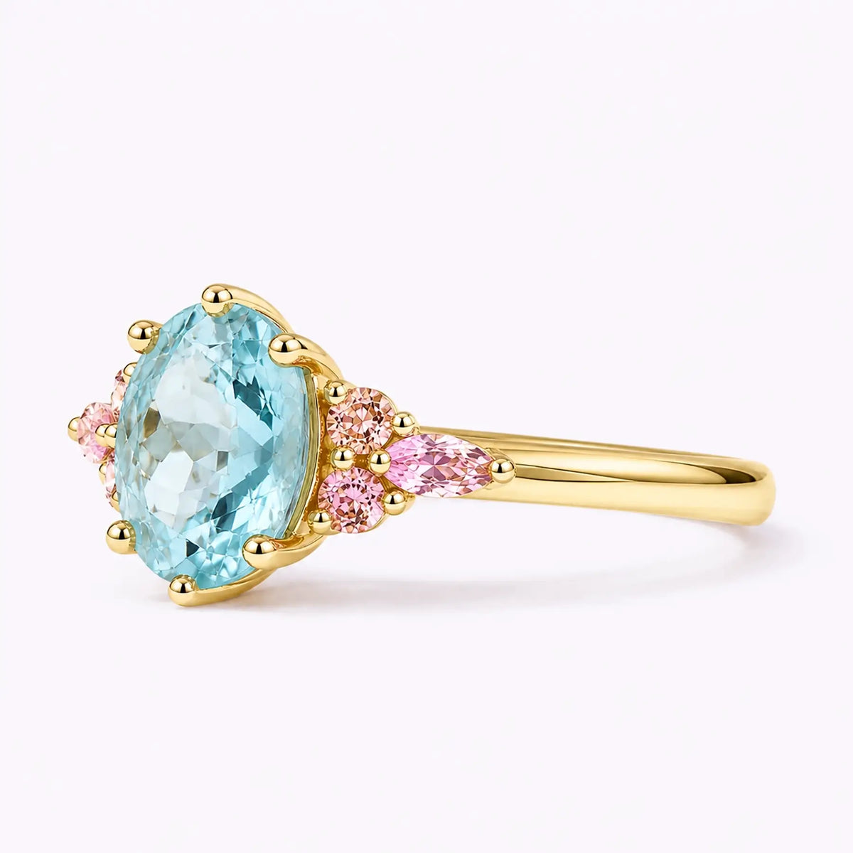 Left view of oval aquamarine ring with pink round and marquise side stones