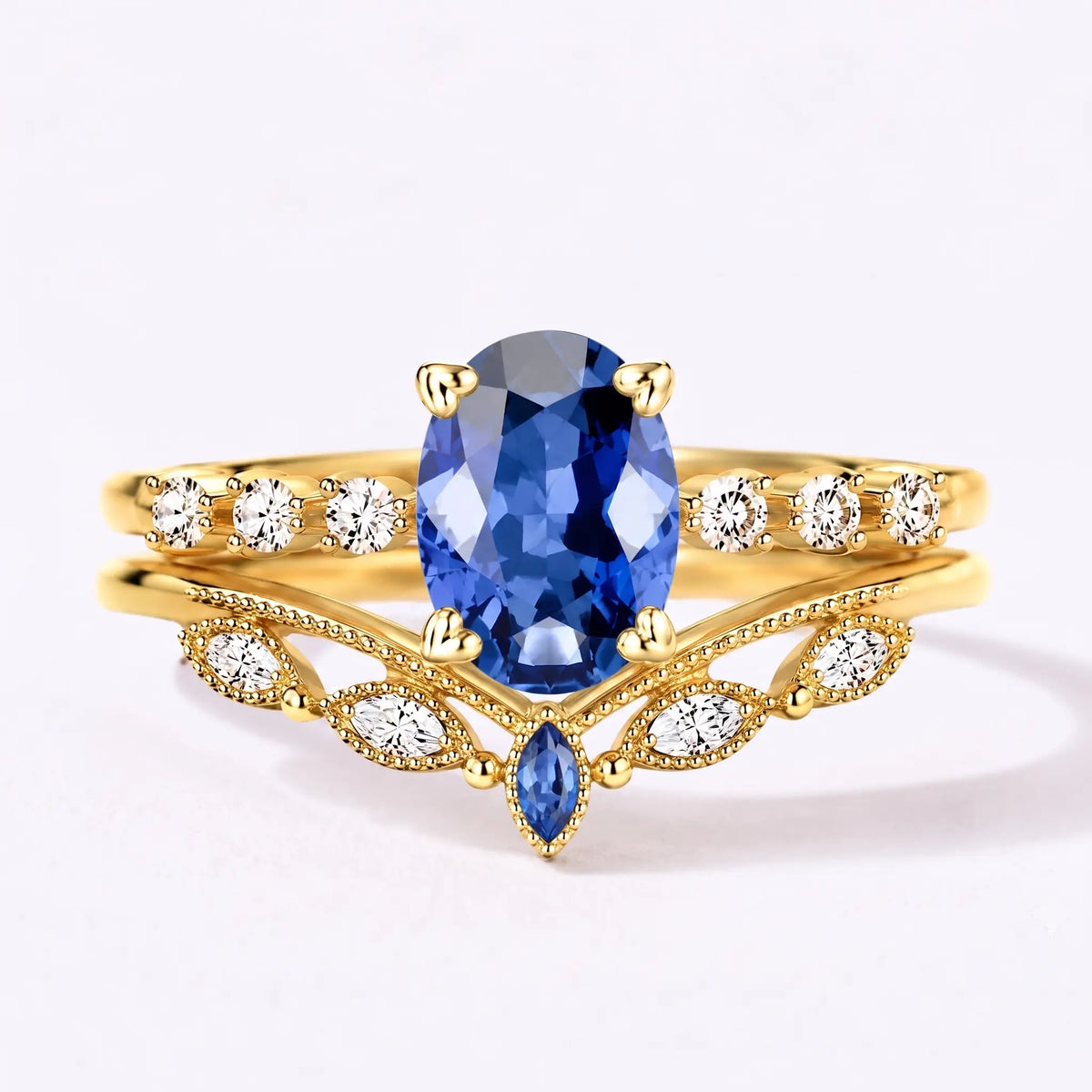 Vintage oval sapphire bridal ring set with chevron wedding band in yellow gold
