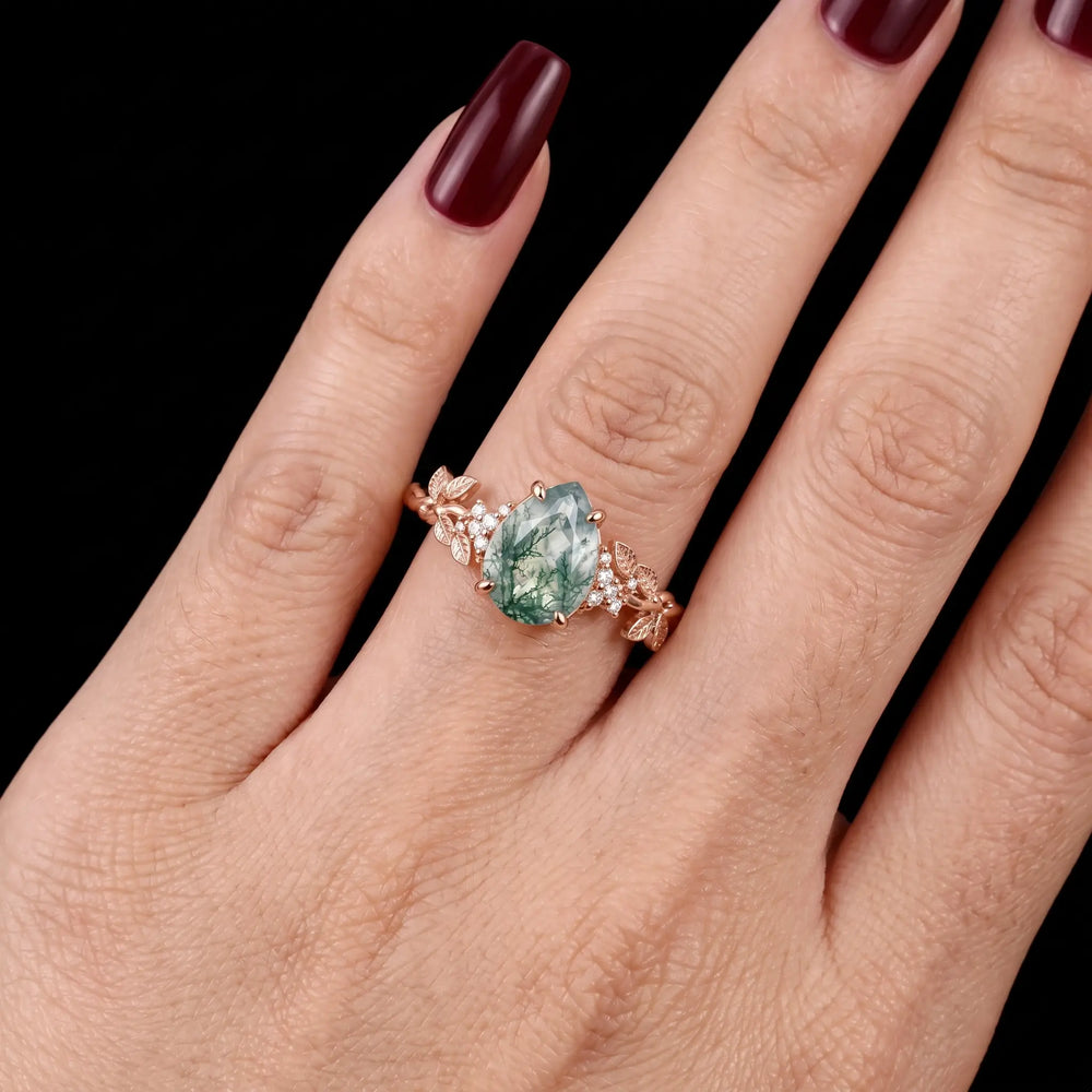 Nature inspired pear moss agate ring worn as an engagement ring