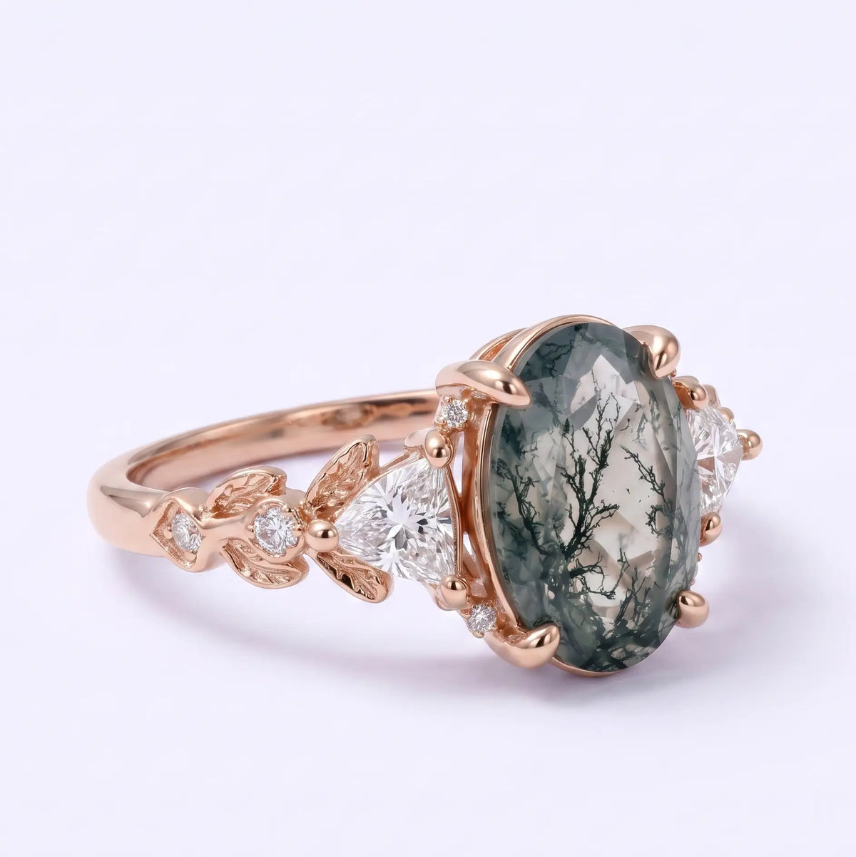 Close-up of trillion moissanite side stones on moss agate ring