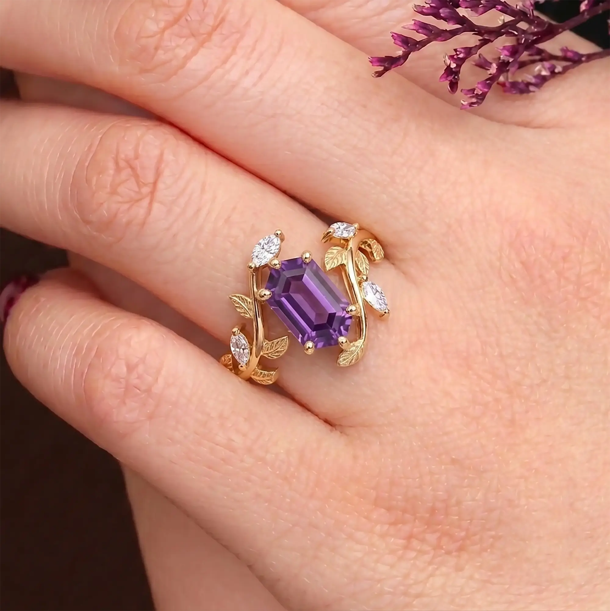 Elongated hexagon sapphire ring worn on hand with organic leaf-inspired design