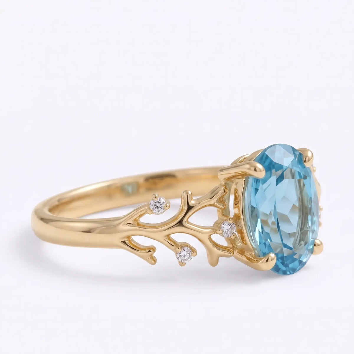 Three quarter view of oval blue topaz reef inspired gold ring