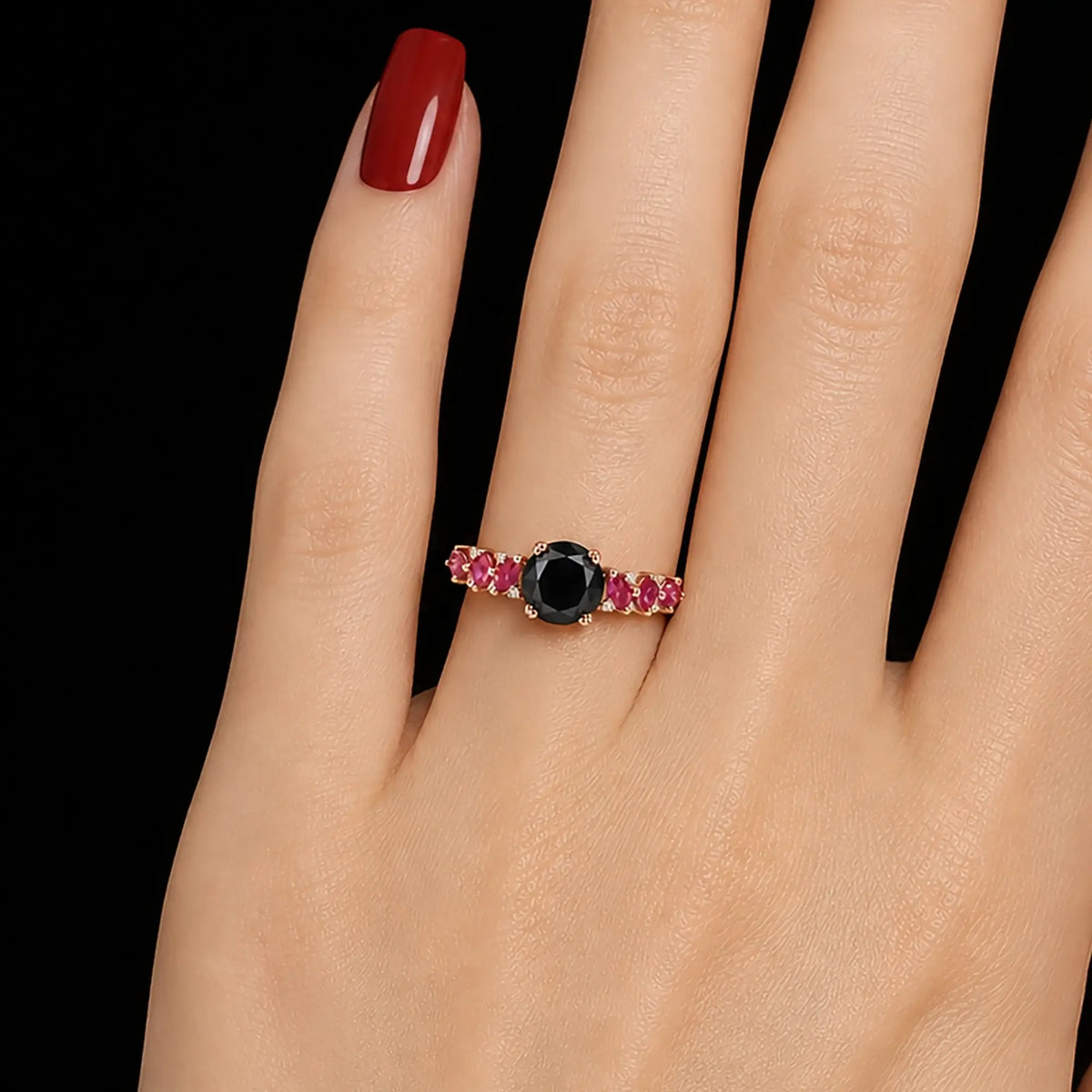 Round black moissanite ring worn on hand with ruby cluster accents
