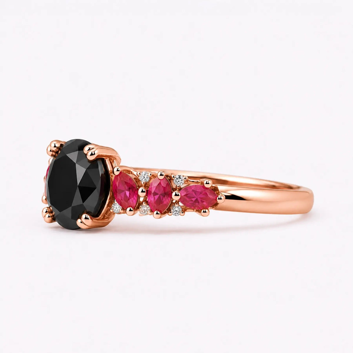 Left view of black moissanite ring with ruby side stones and double round prongs